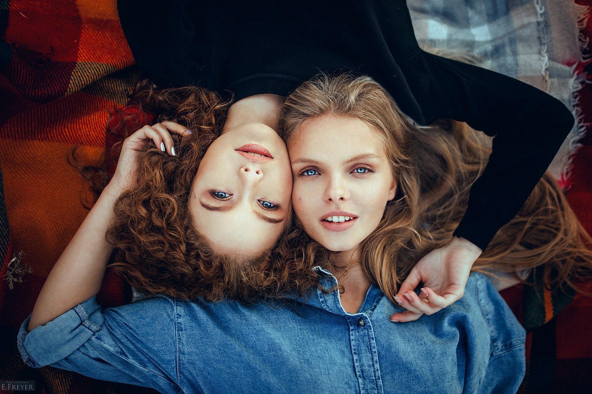 Two young women lying on a blanket HD Wallpaper