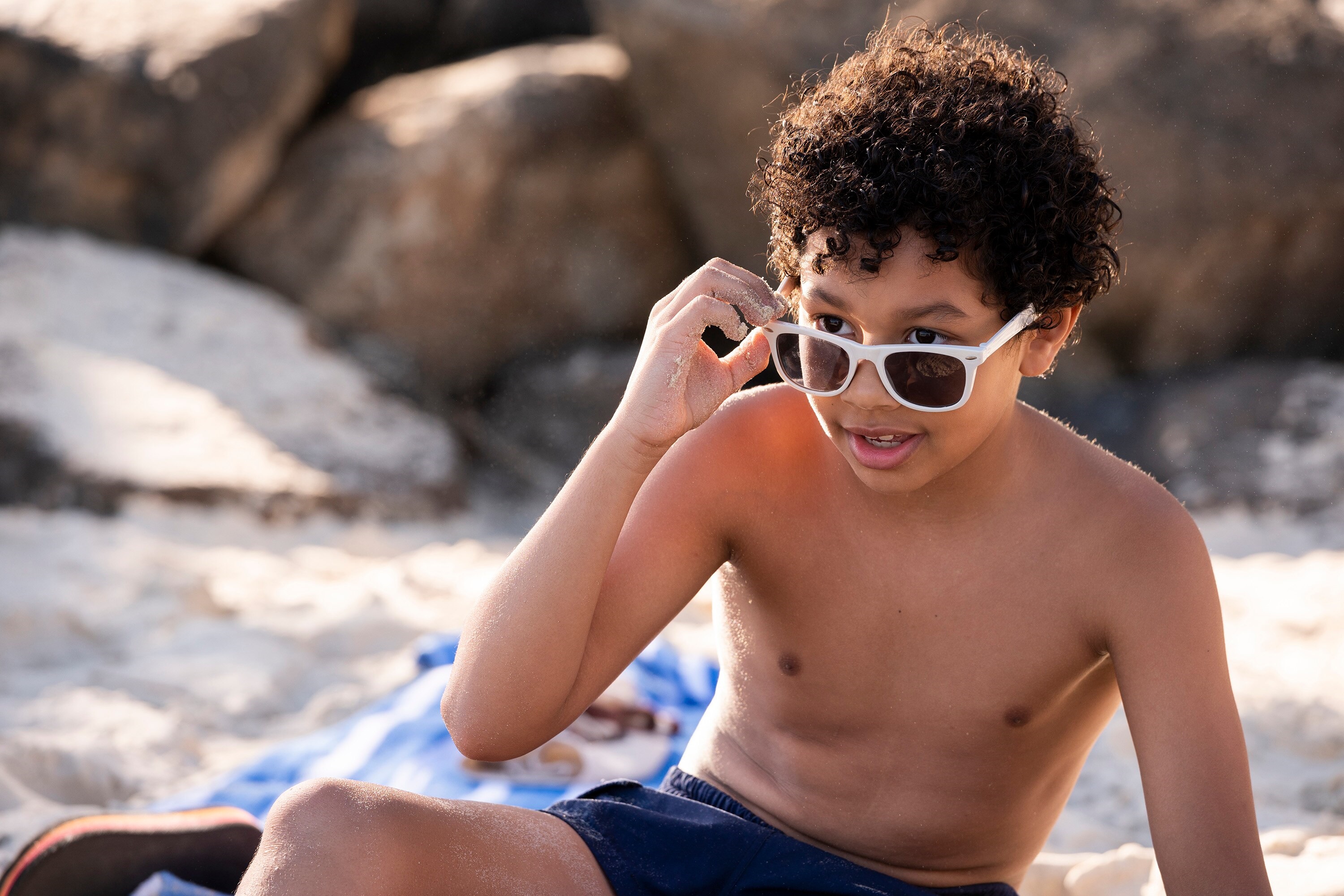 Young boy with sunglasses on the beach HD Wallpaper