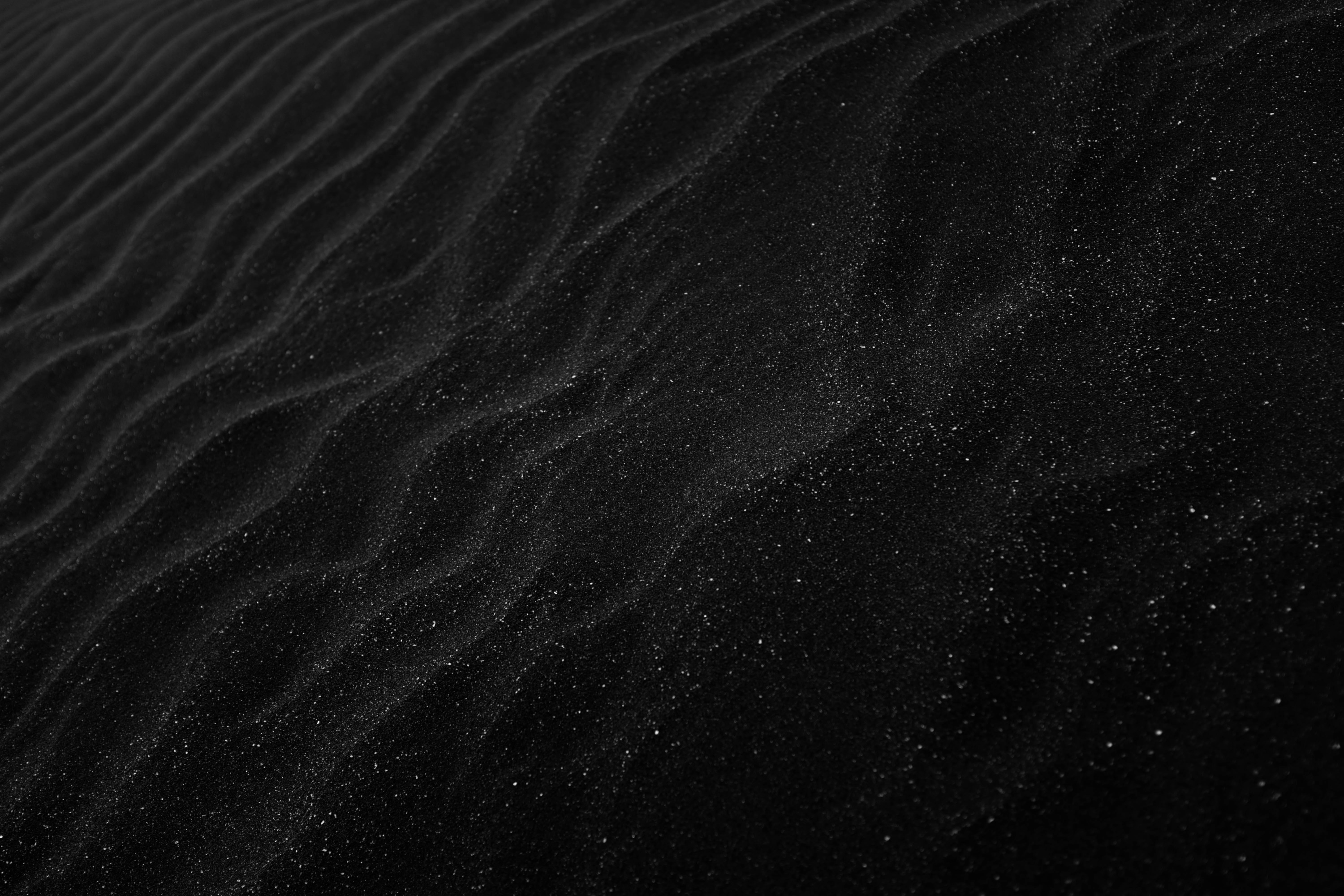 Black sand dunes with wavy patterns HD Wallpaper