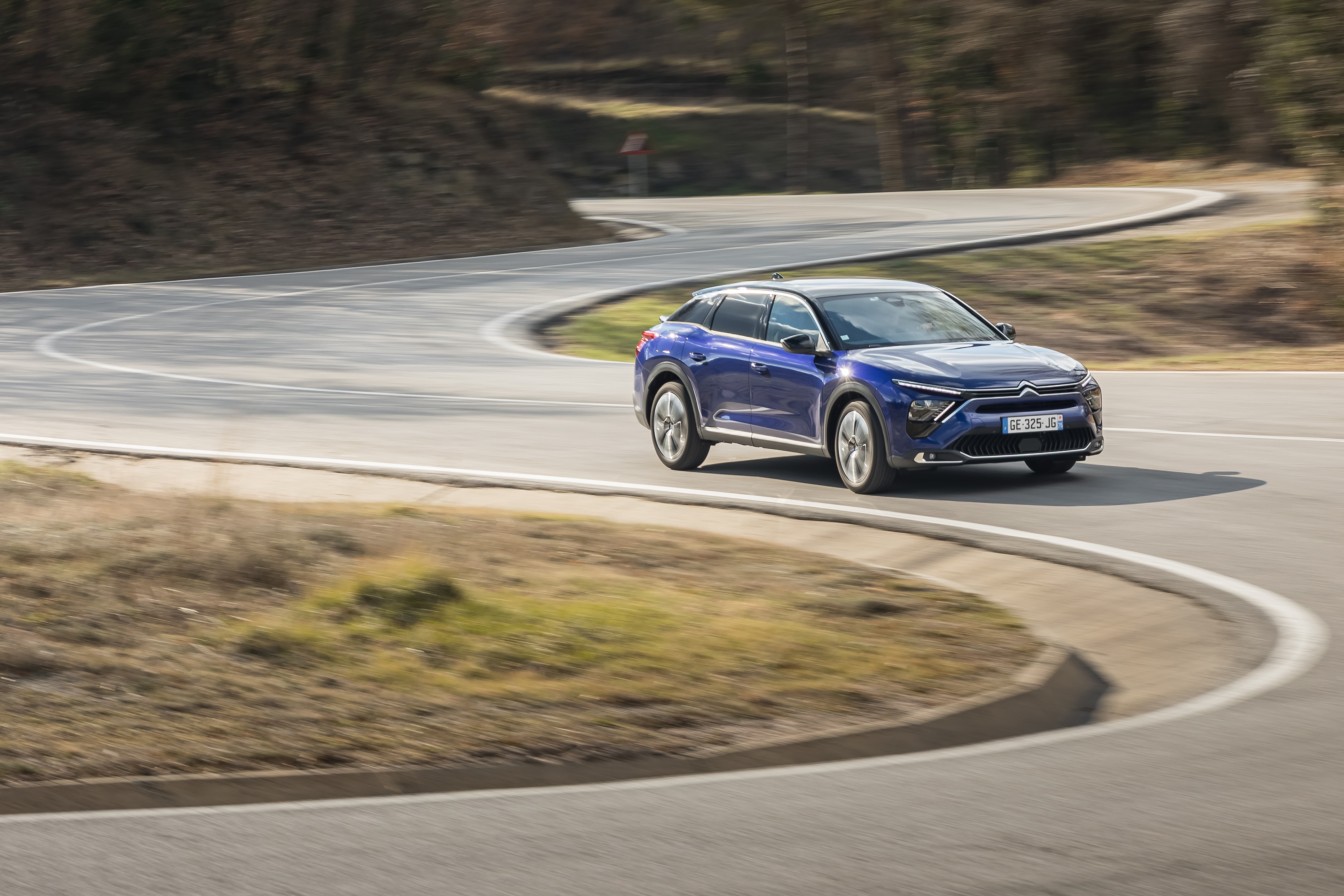 Blue Citroën C5 X driving on a winding road HD Wallpaper