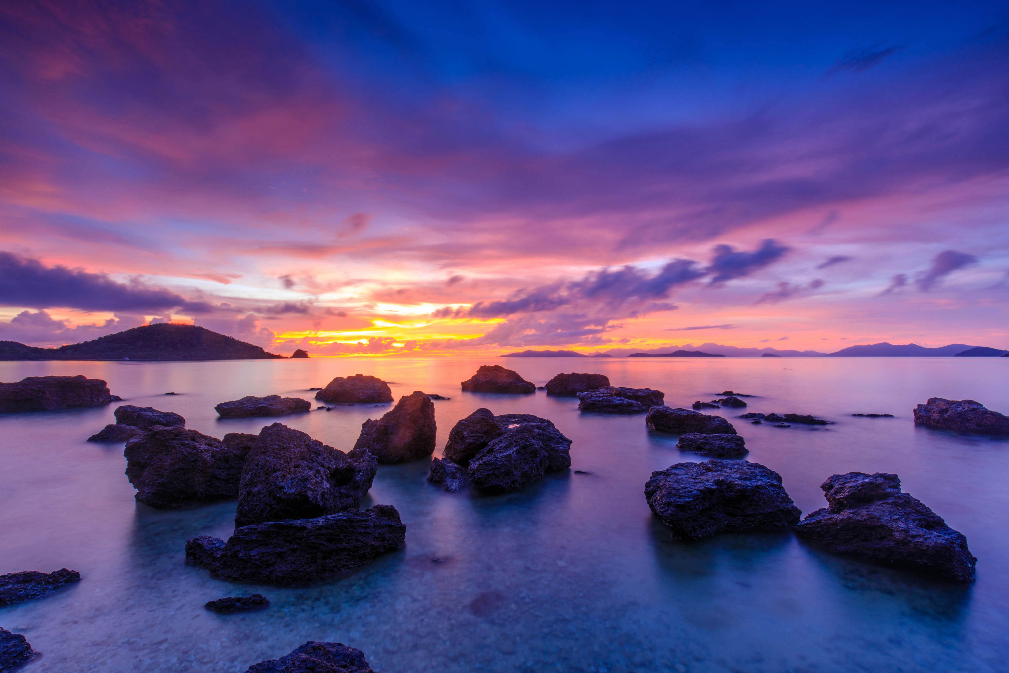 Sunrise over the ocean with rocks HD Wallpaper