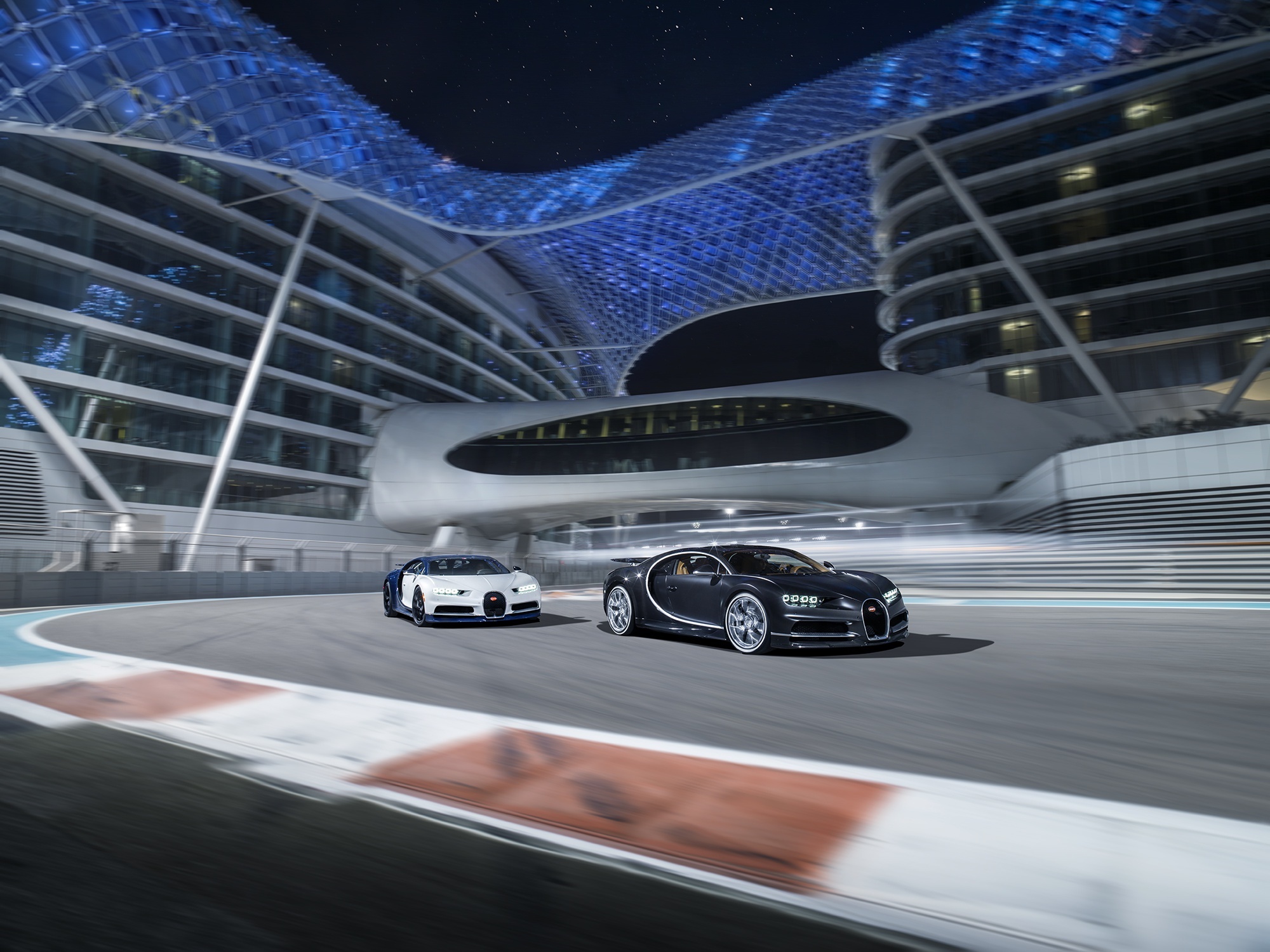 Two Bugatti Chirons on a Race Track at Night HD Wallpaper