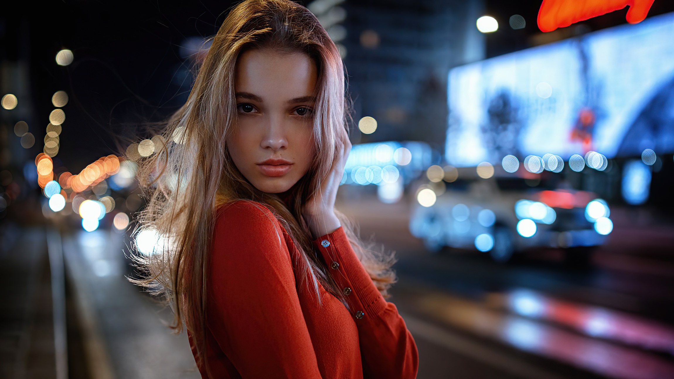Young woman in red sweater at night HD Wallpaper