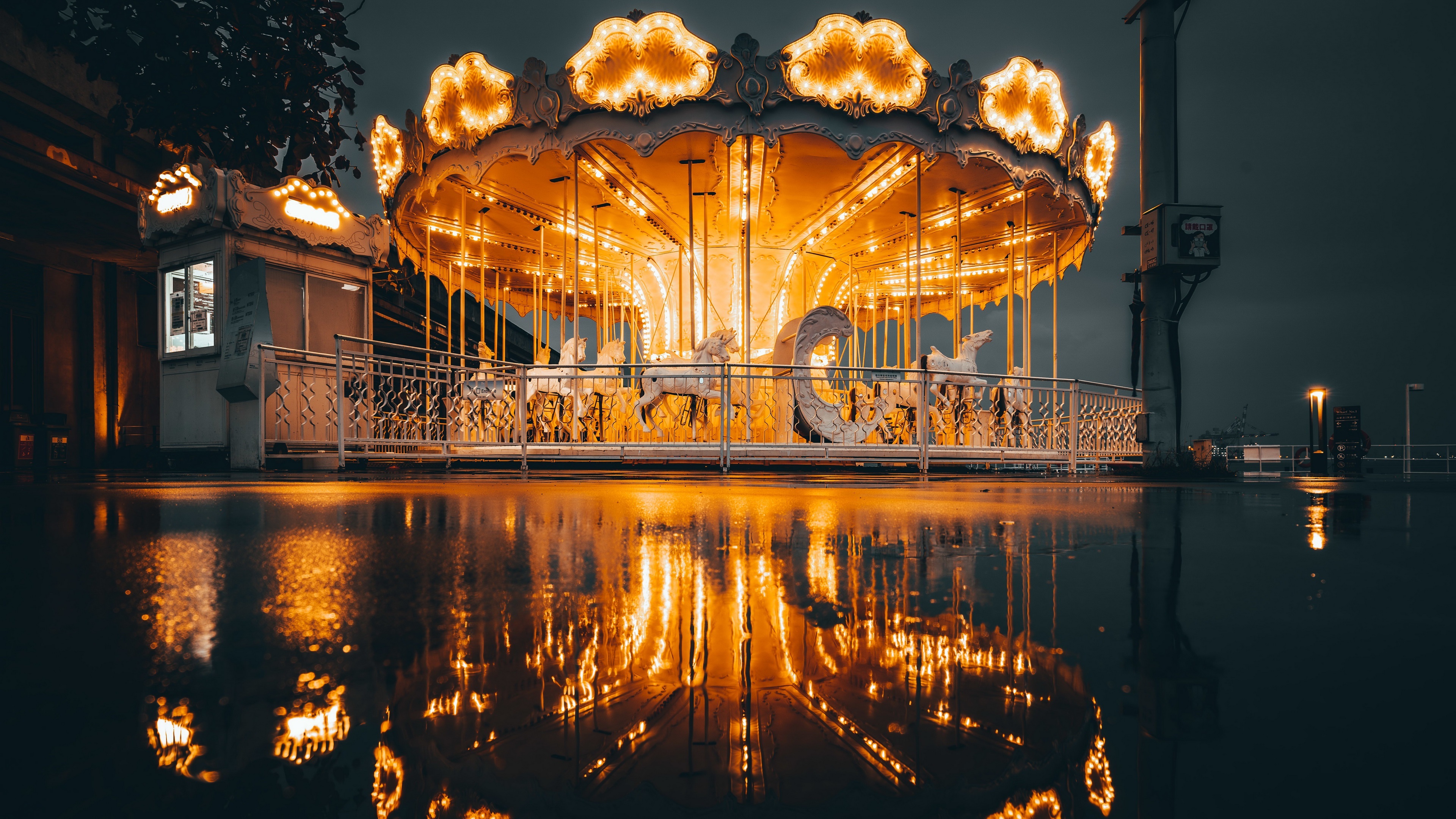 Carousel with illuminated horses at night HD Wallpaper