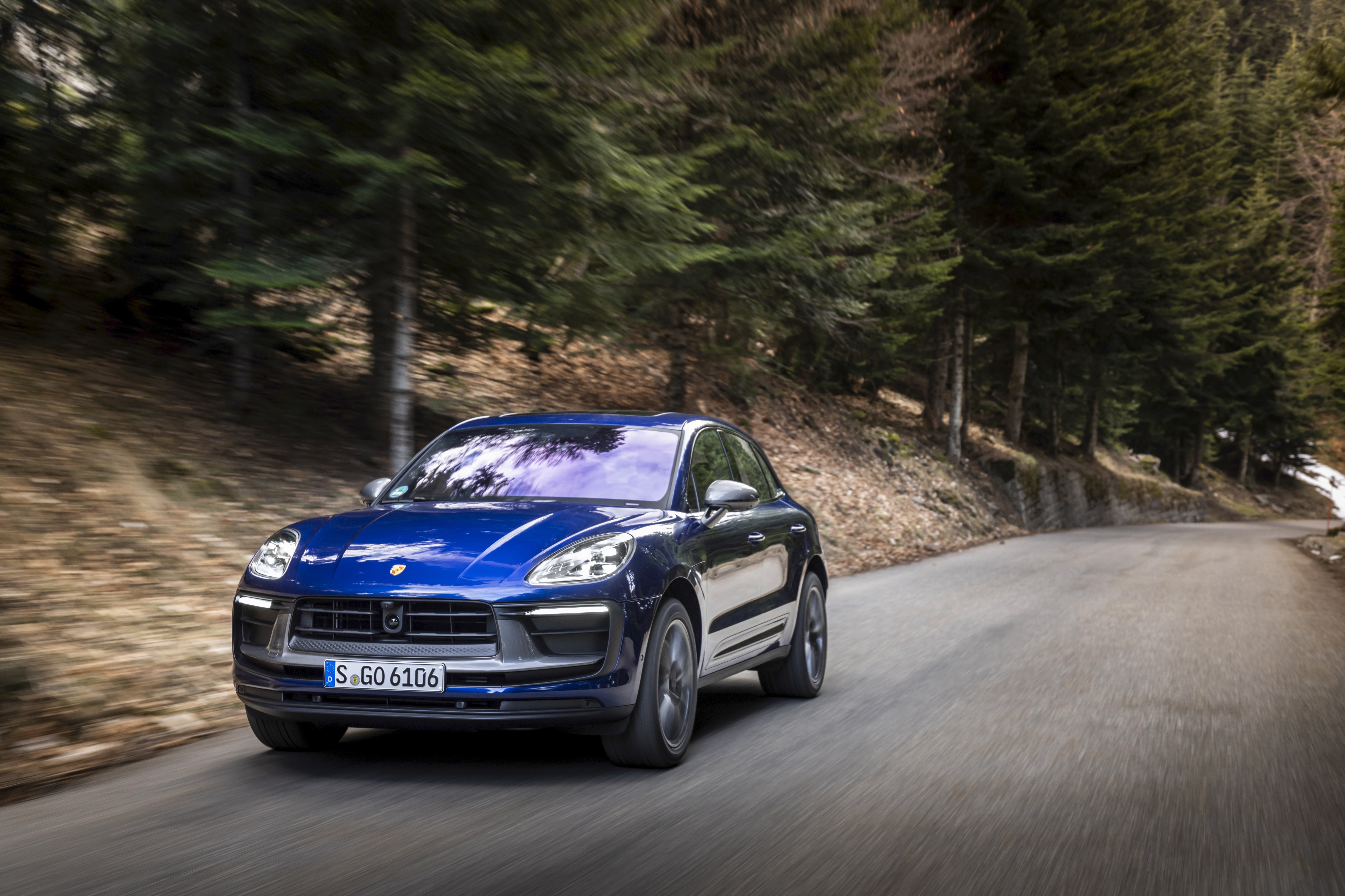 Blue Porsche Macan Turbo driving on a forest road HD Wallpaper