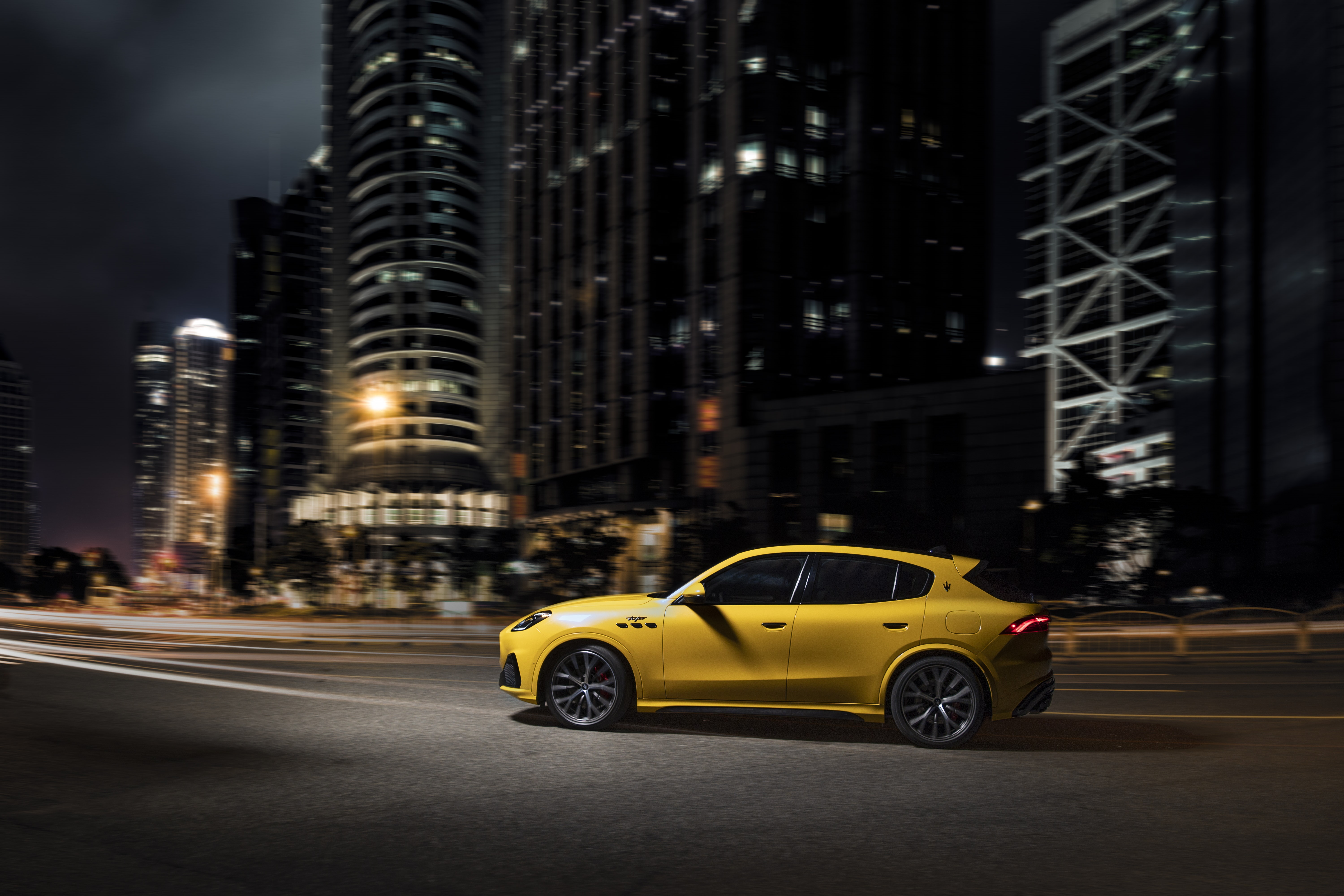 Yellow Maserati Grecale Trofeo driving at night HD Wallpaper