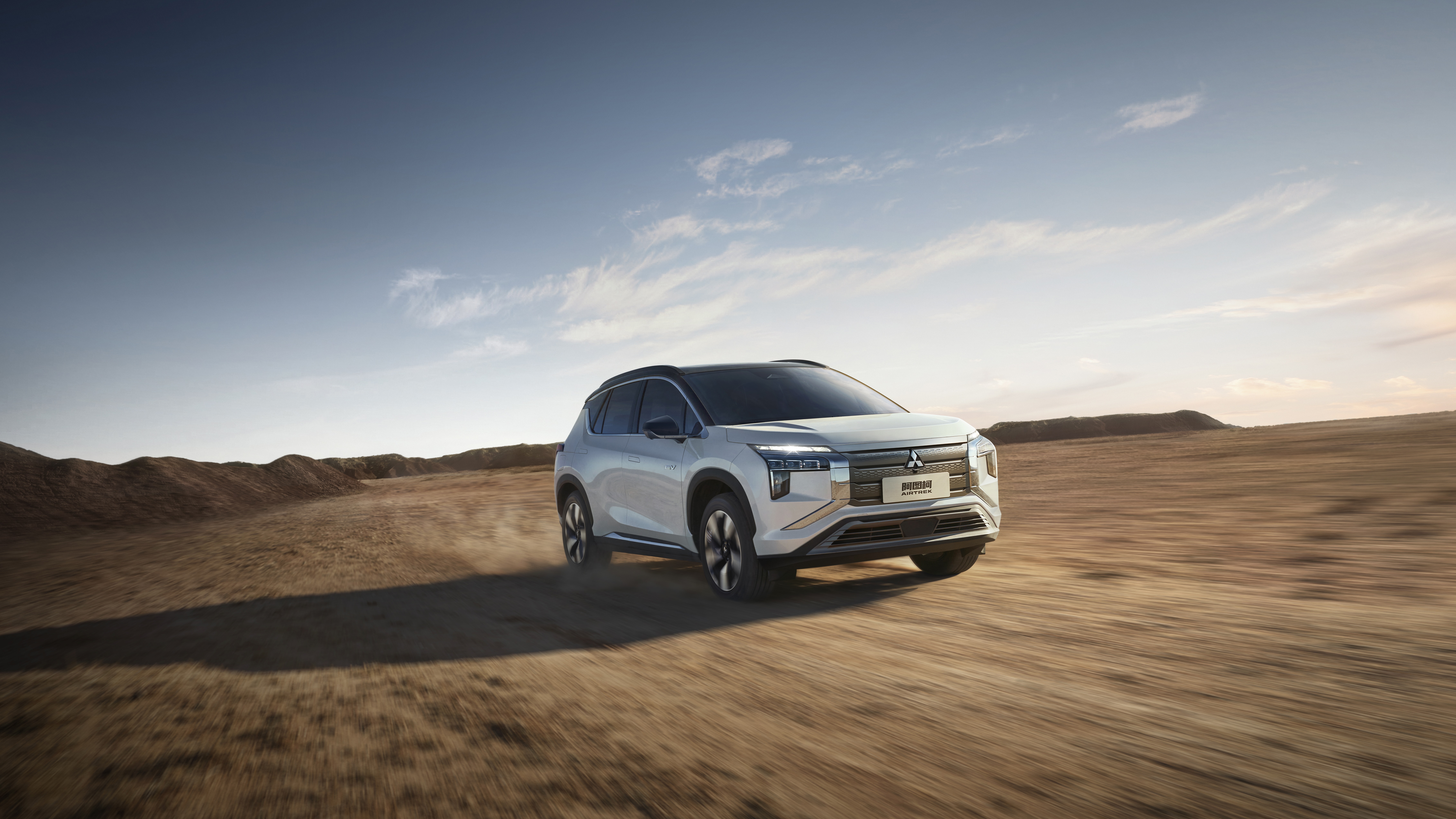 Mitsubishi Airtrek driving on a dirt road HD Wallpaper
