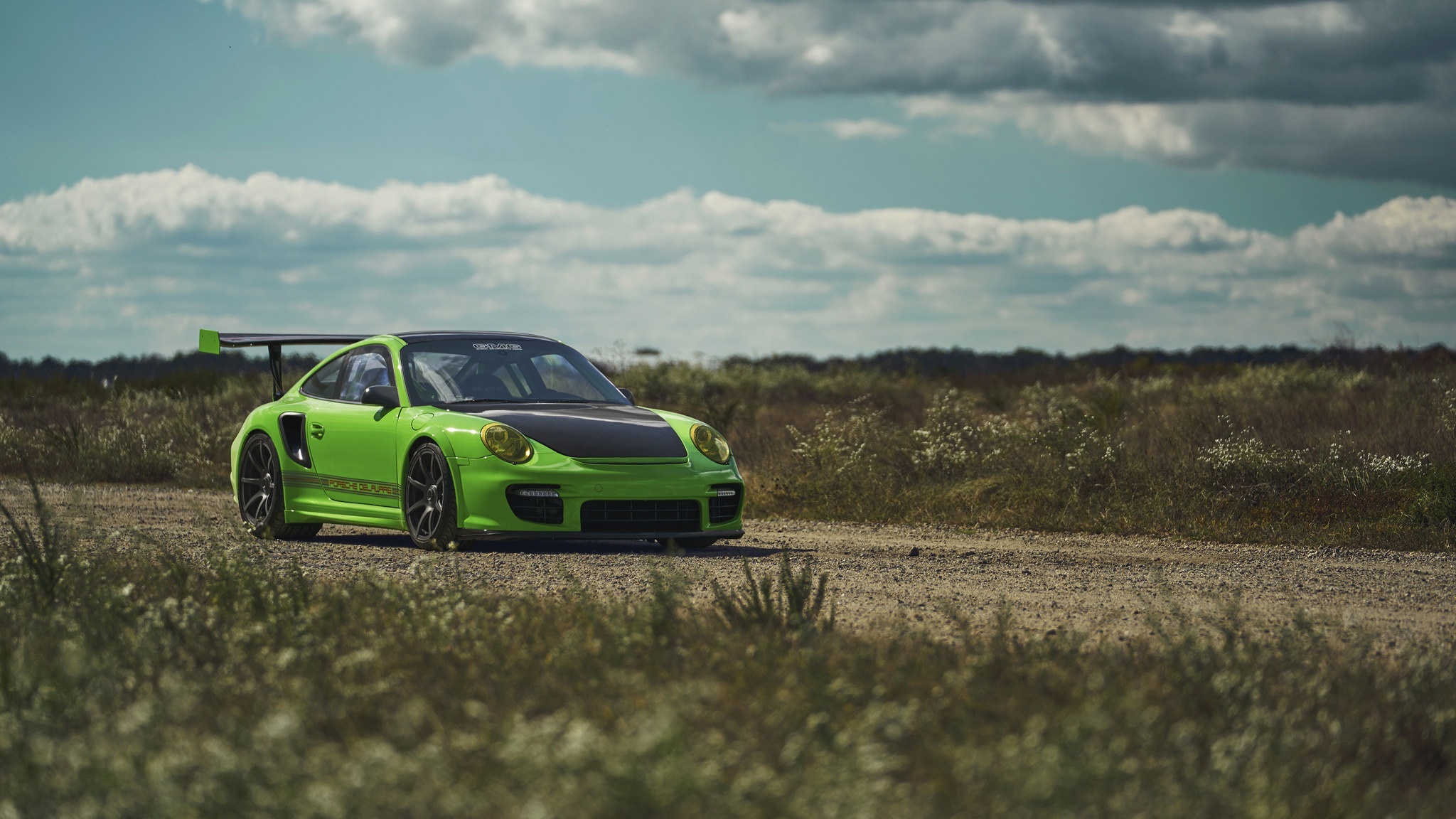 Green Porsche 911 GT2 on a dirt road HD Wallpaper