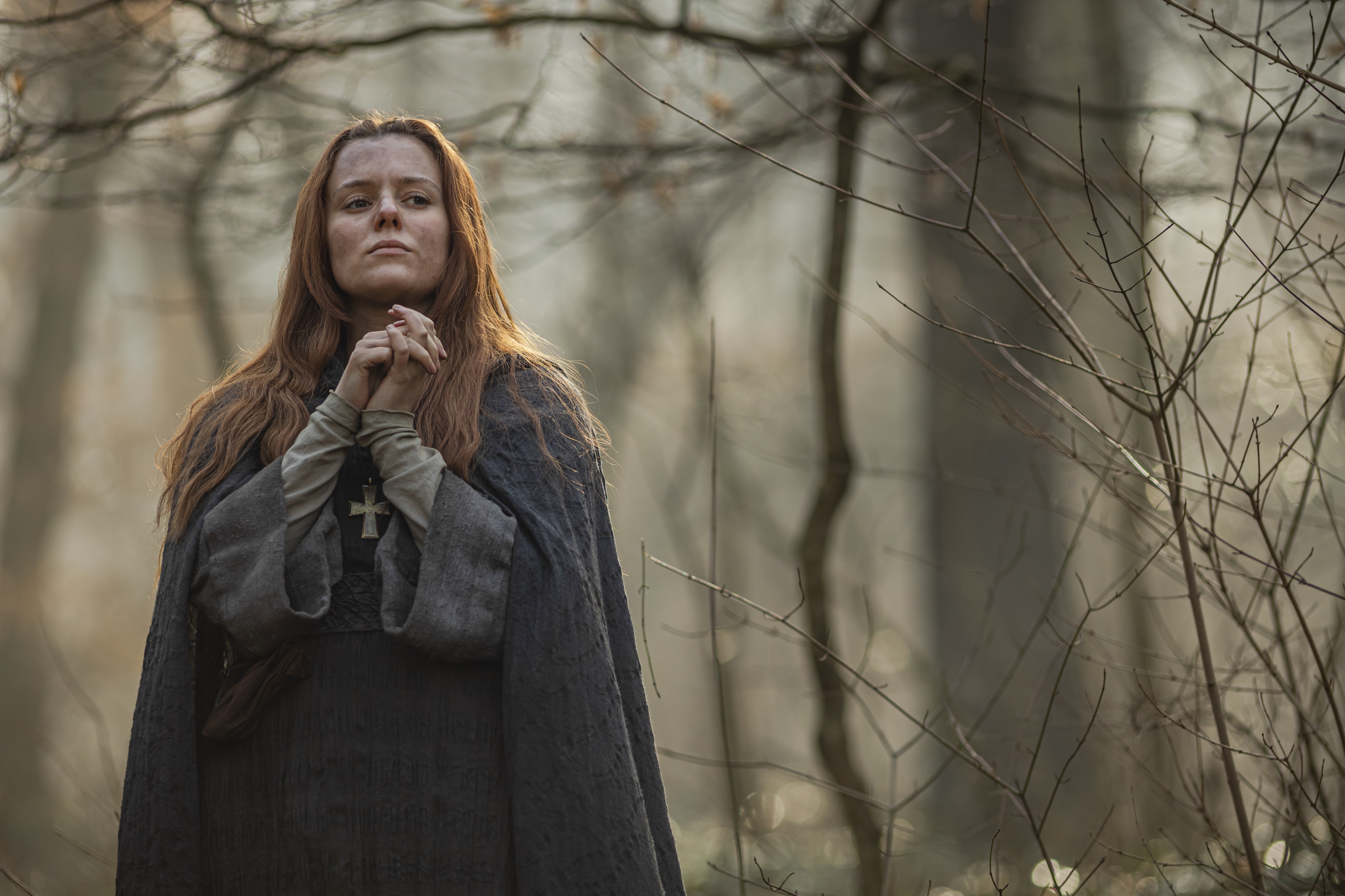 Woman in medieval dress praying in forest HD Wallpaper