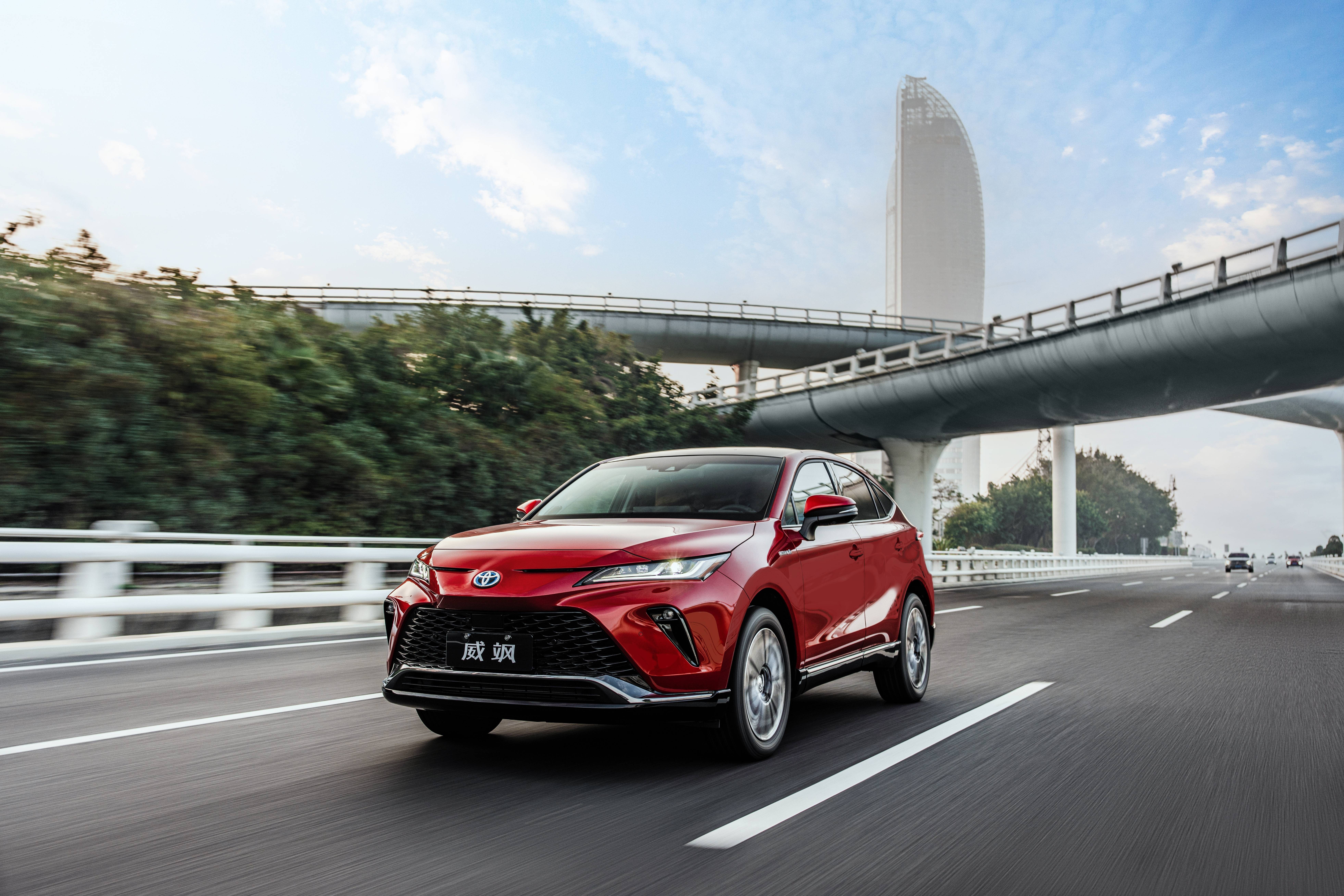 Red Toyota Venza Hybrid driving on a highway HD Wallpaper