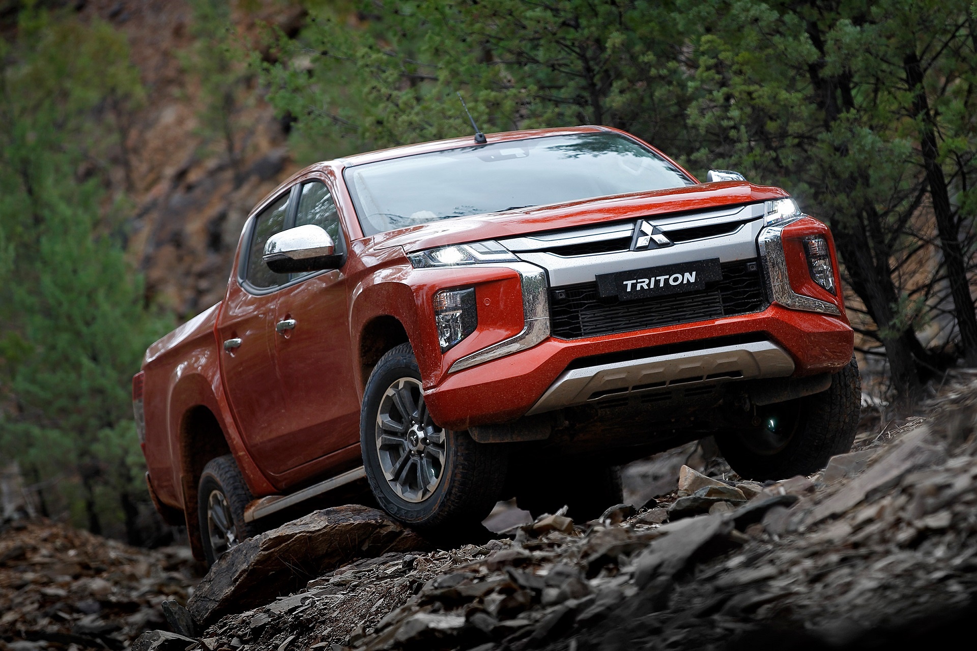 Mitsubishi Triton pickup truck driving on rocky terrain HD Wallpaper