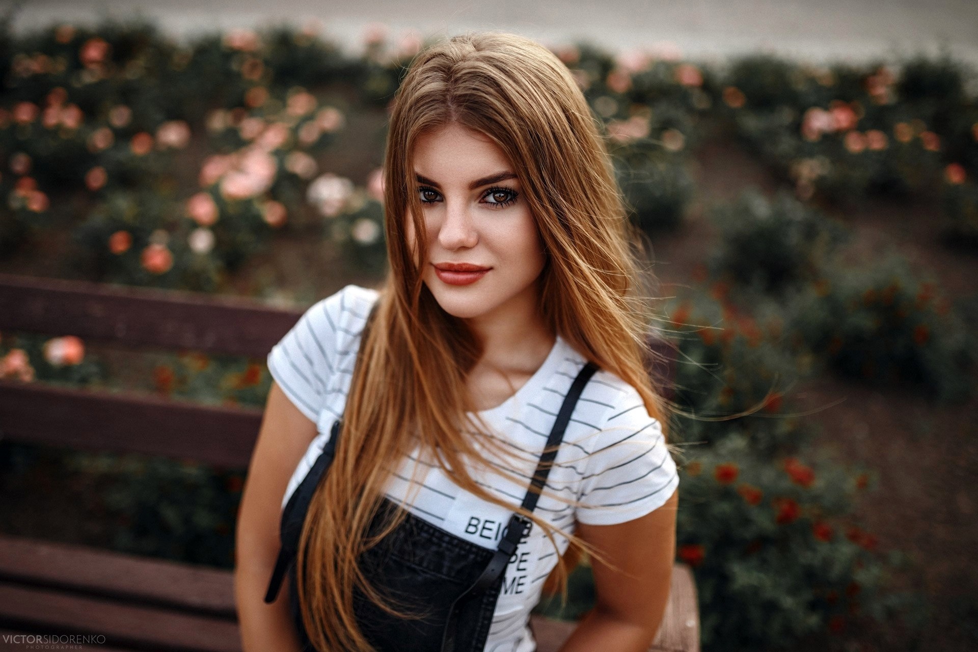 Young woman with long blonde hair sitting on a bench HD Wallpaper