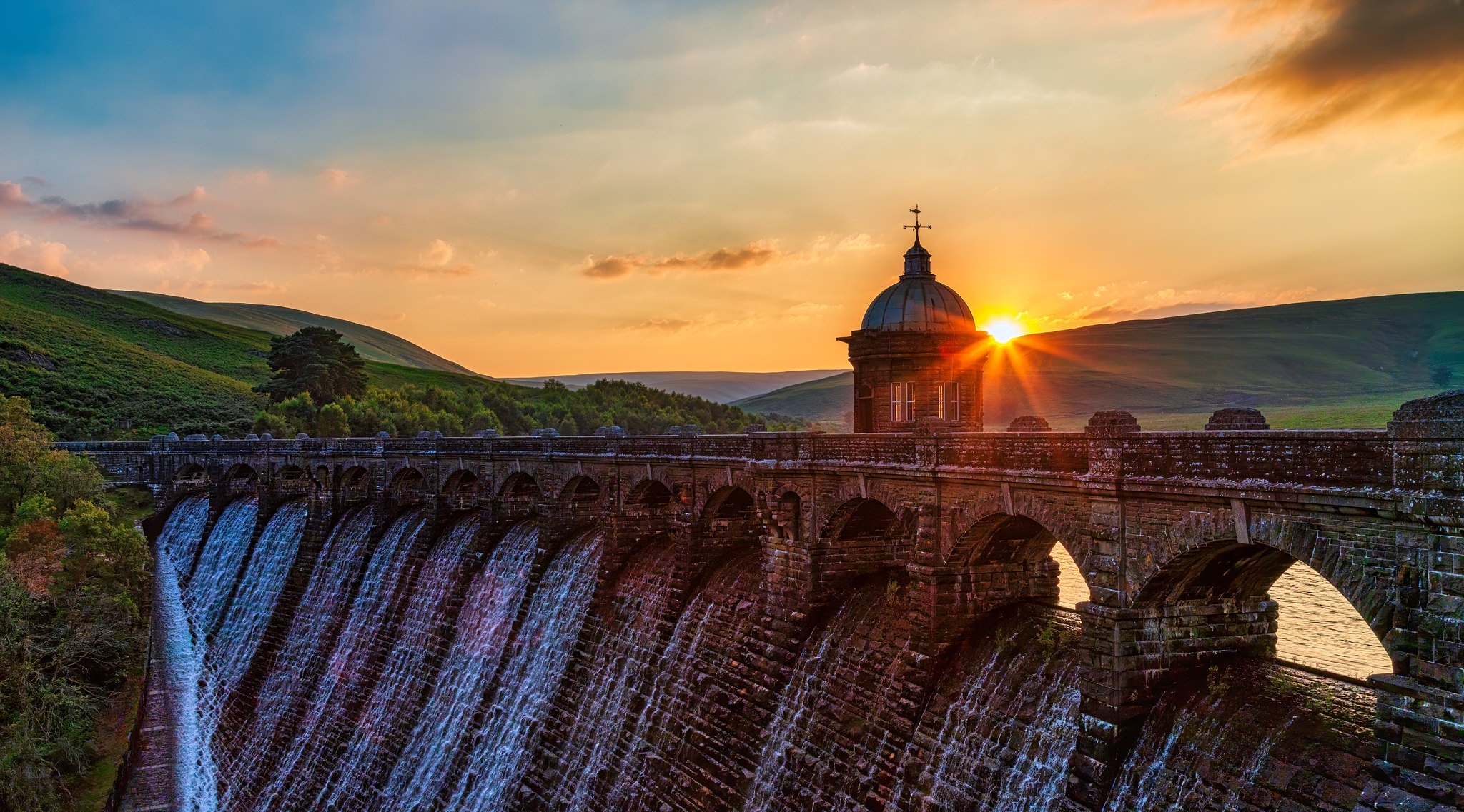 Dam with water flowing at sunset HD Wallpaper
