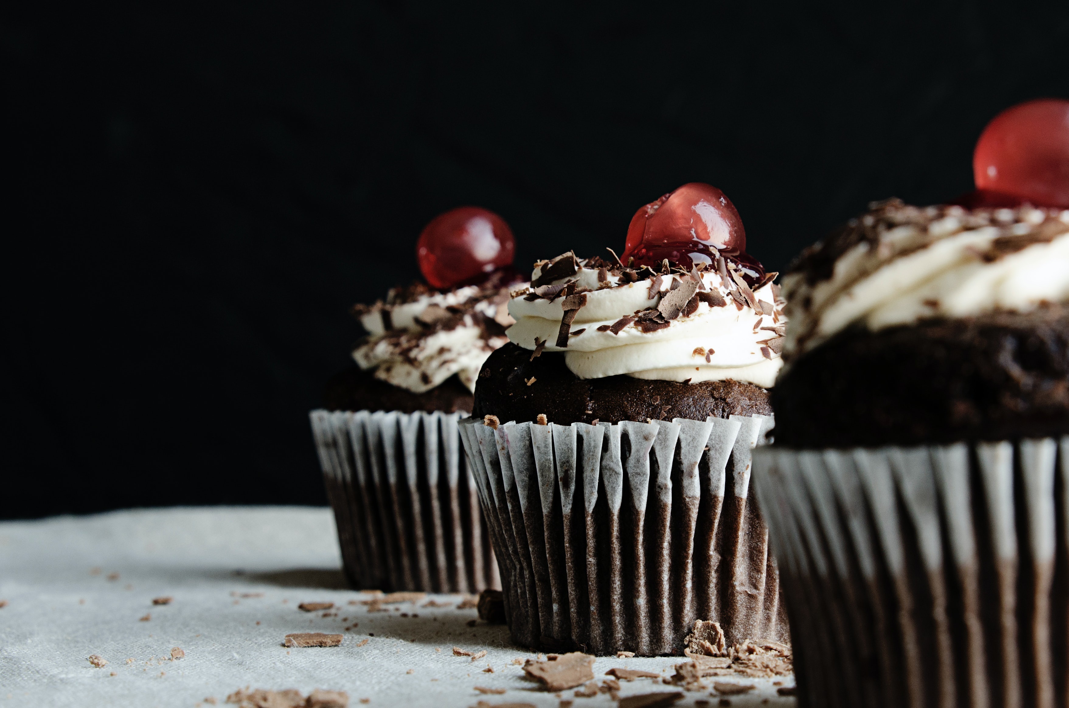 Chocolate cupcakes with whipped cream and cherries HD Wallpaper