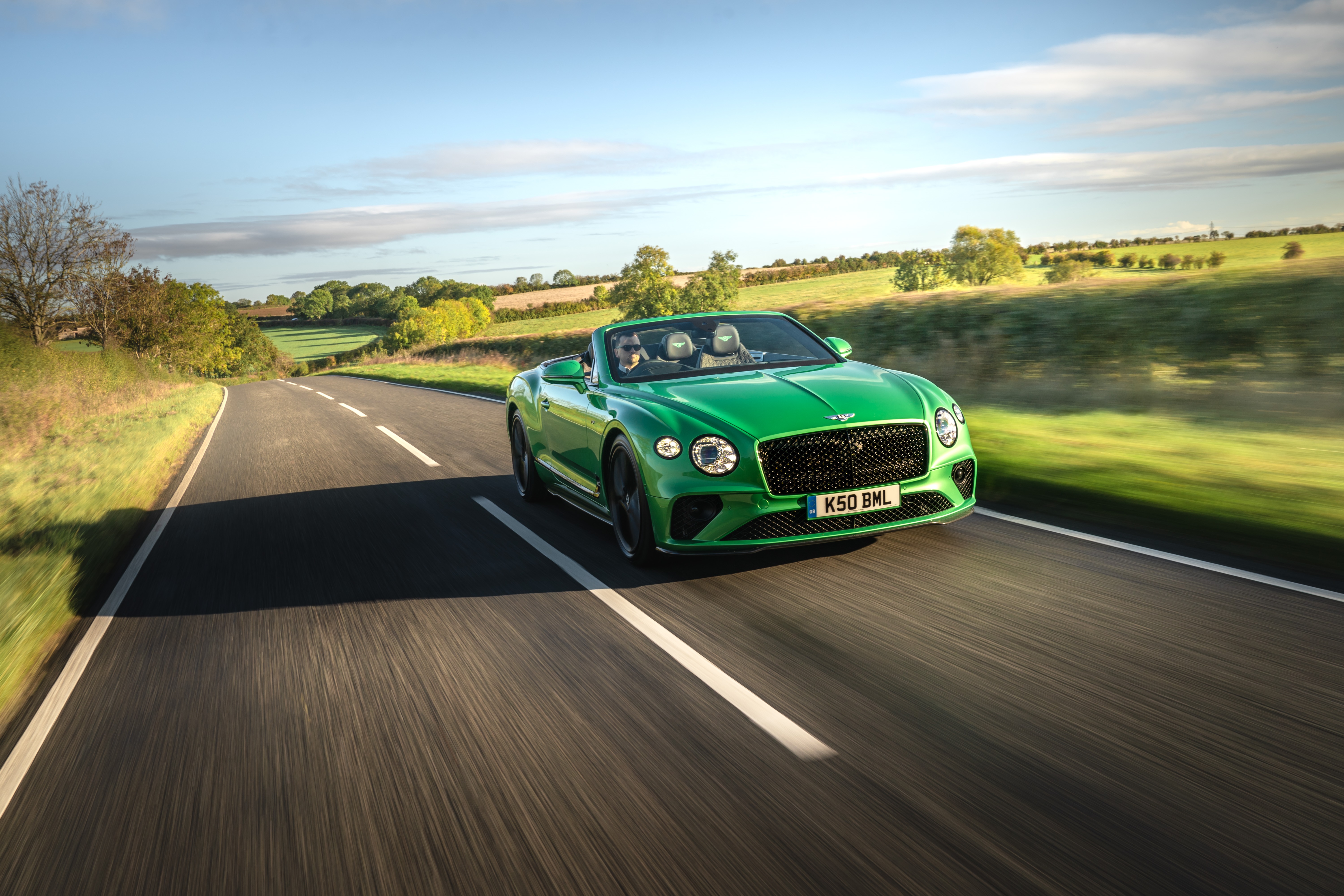 Green Bentley Continental GT V8 Convertible driving on road HD Wallpaper