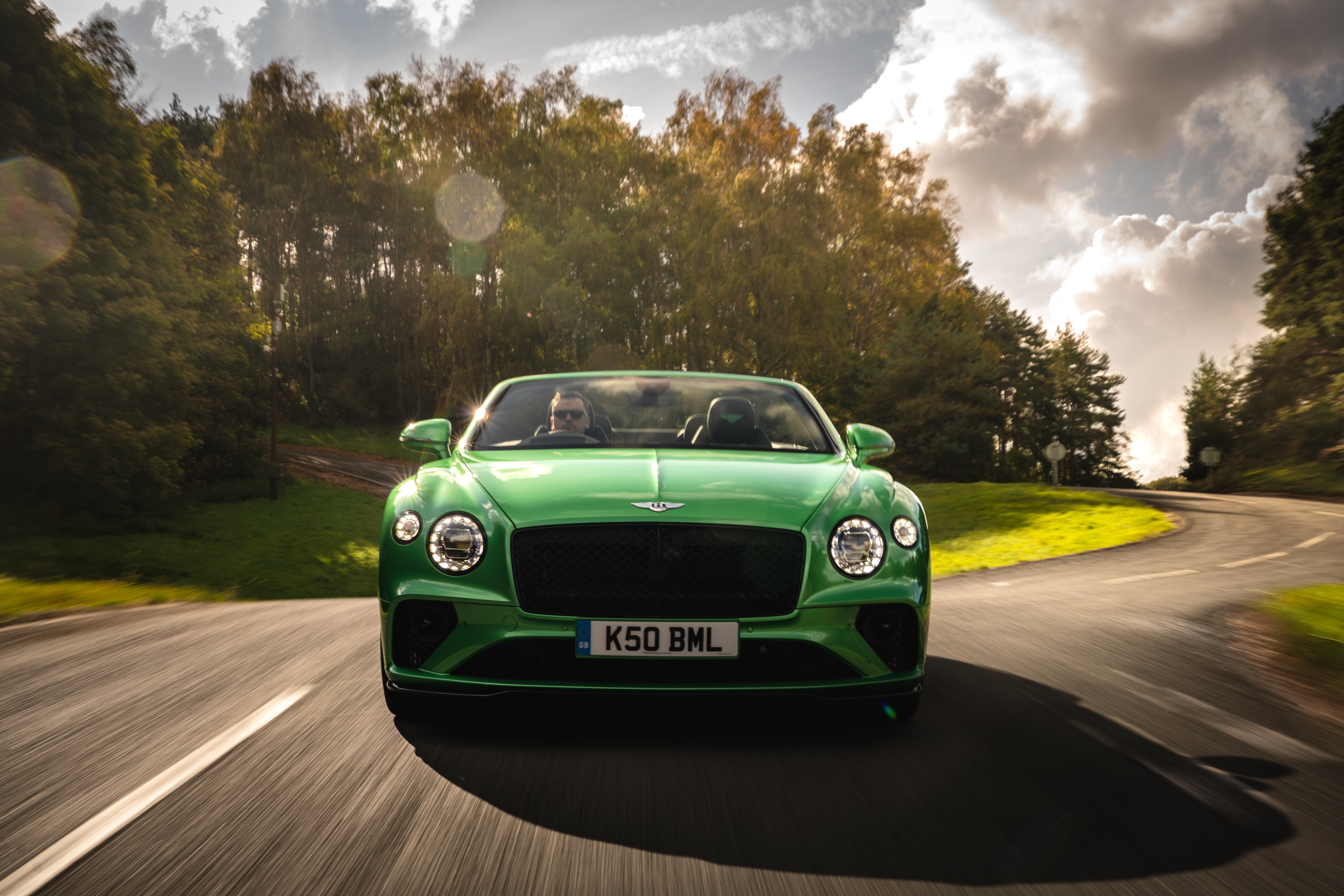 Green Bentley Continental GT V8 Convertible driving on road HD Wallpaper