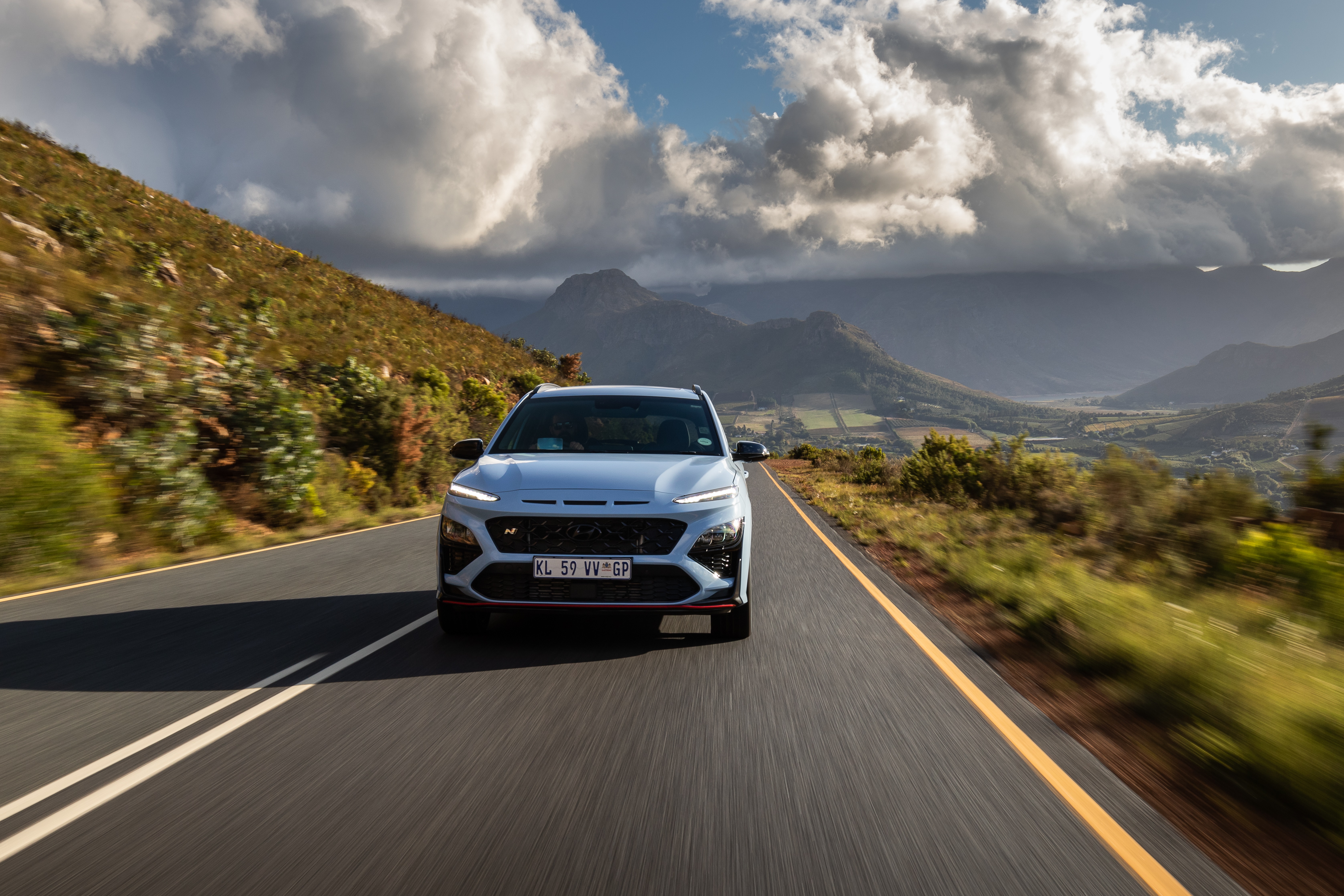 Hyundai Kona N driving on a mountain road HD Wallpaper