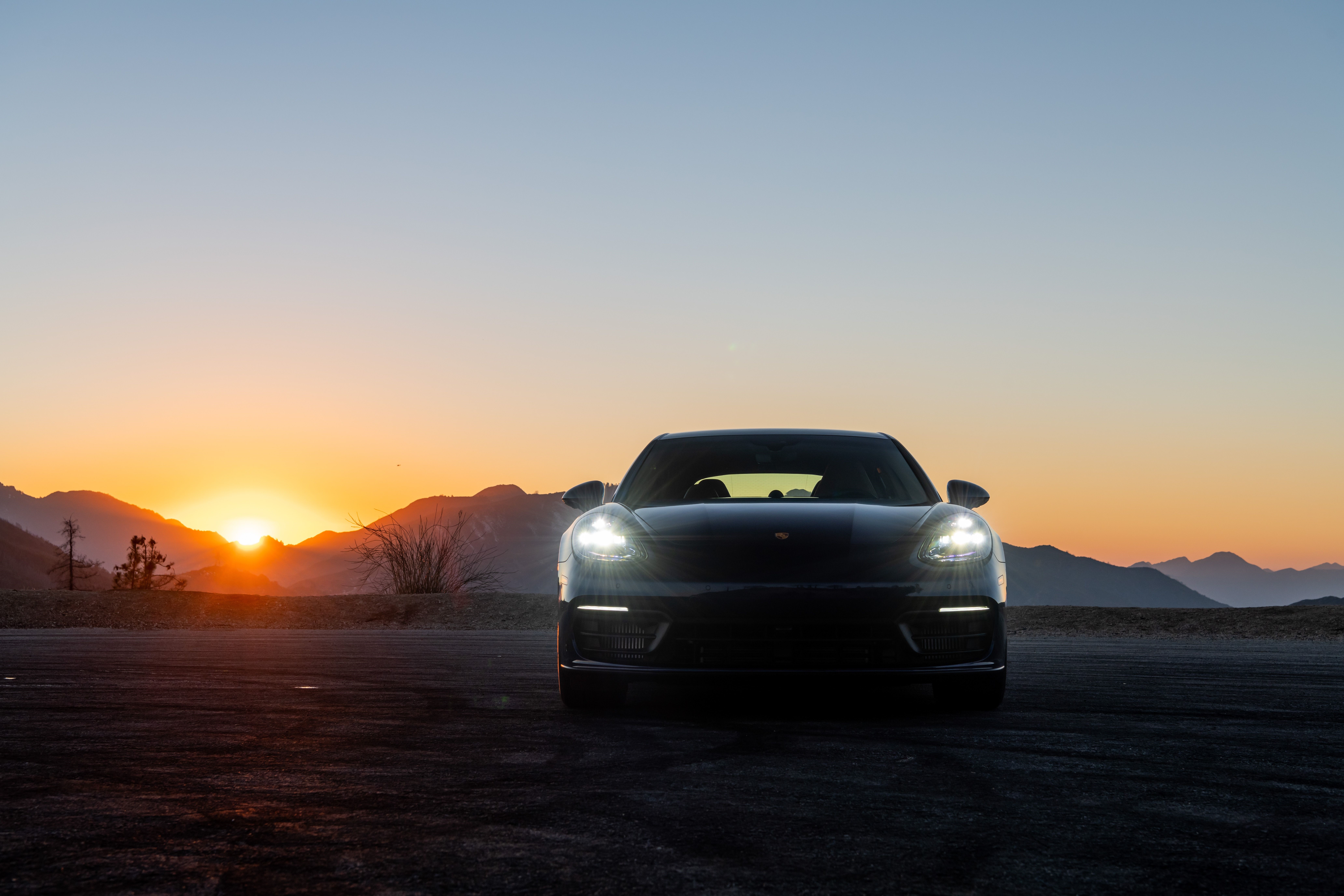 Black Porsche Panamera at Sunset in Desert Mountains HD Wallpaper
