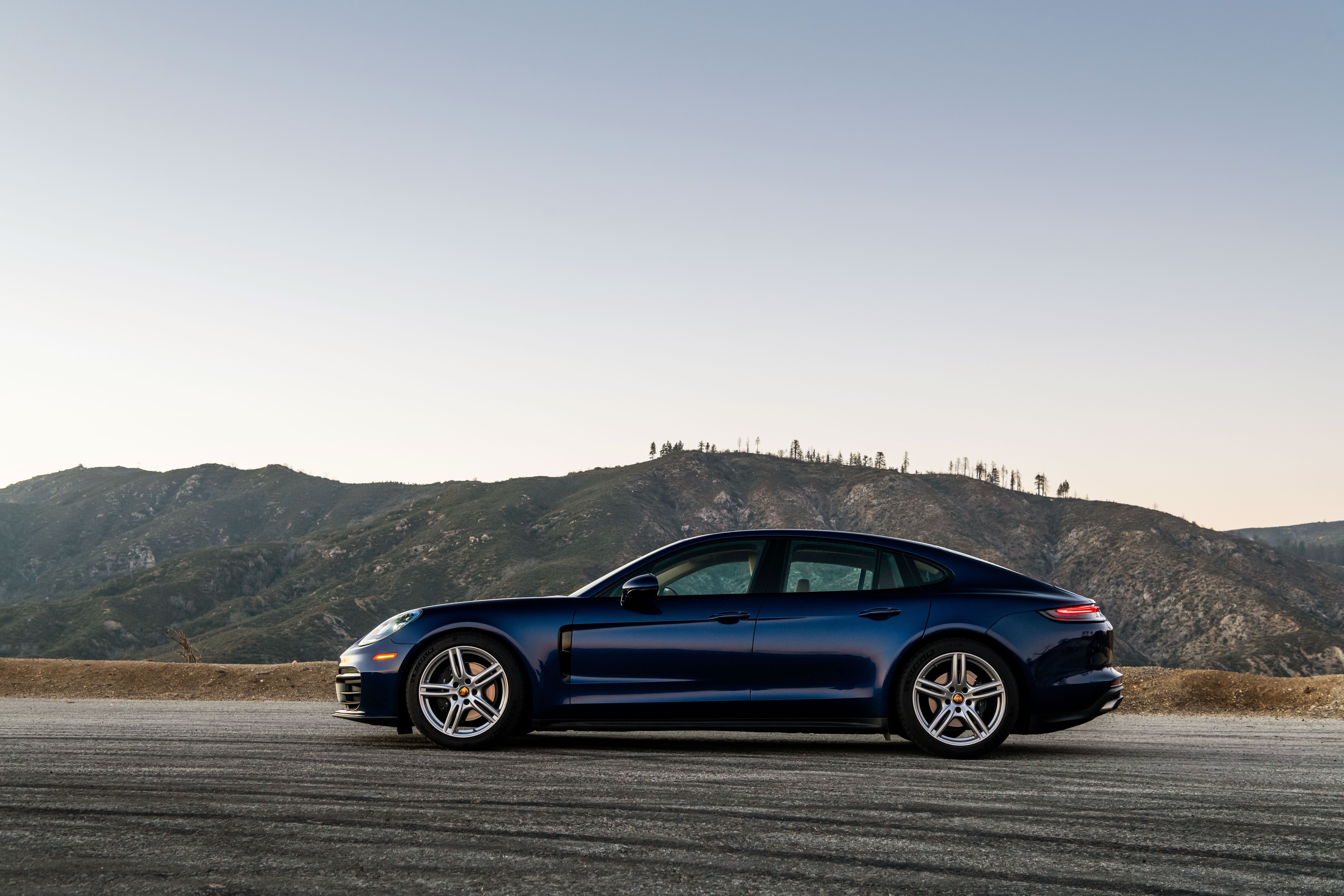 Blue Porsche Panamera on a mountain road HD Wallpaper