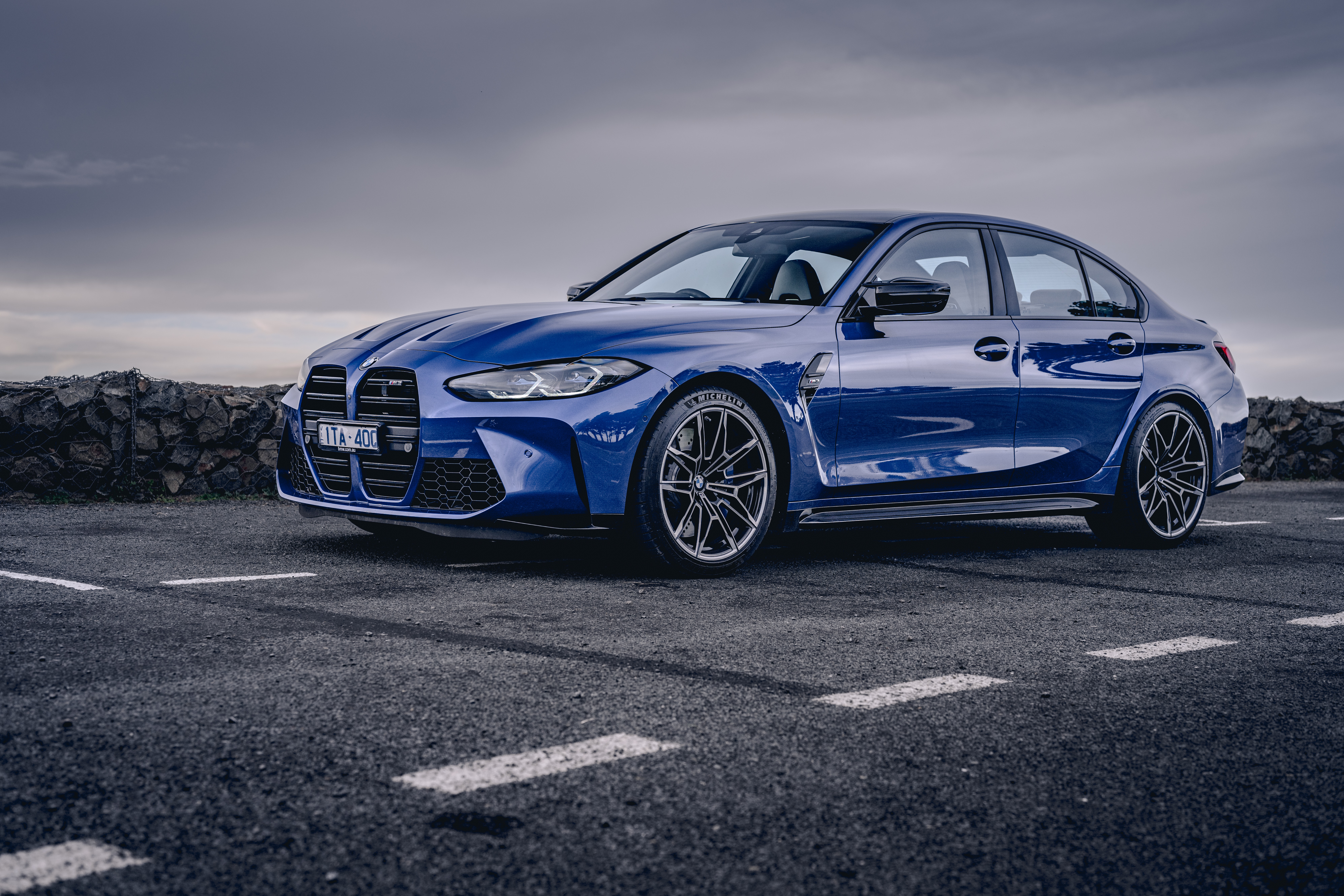 Blue BMW M3 Sedan on Paved Surface HD Wallpaper