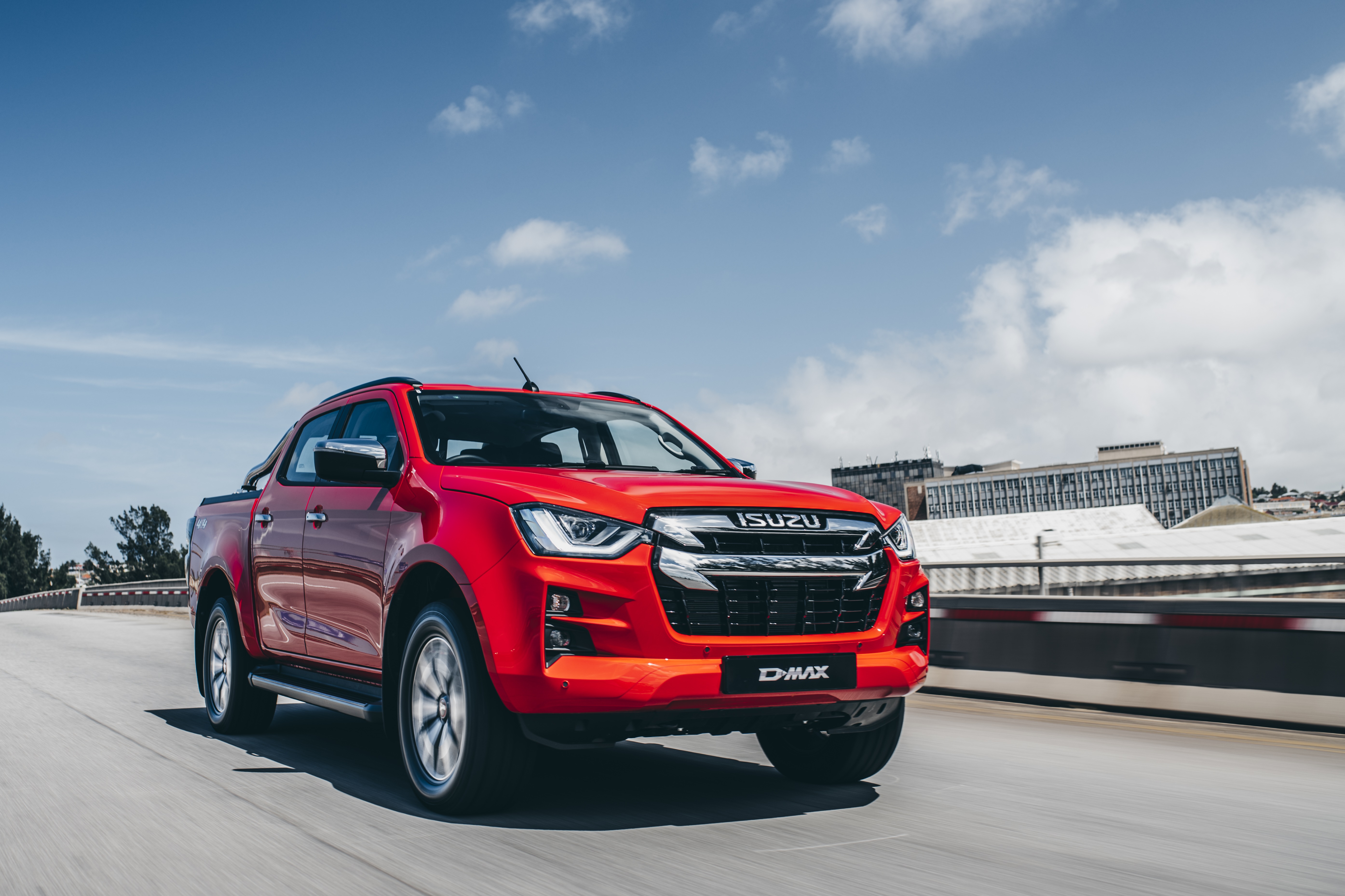 Red Isuzu D-Max 4K driving on a road HD Wallpaper