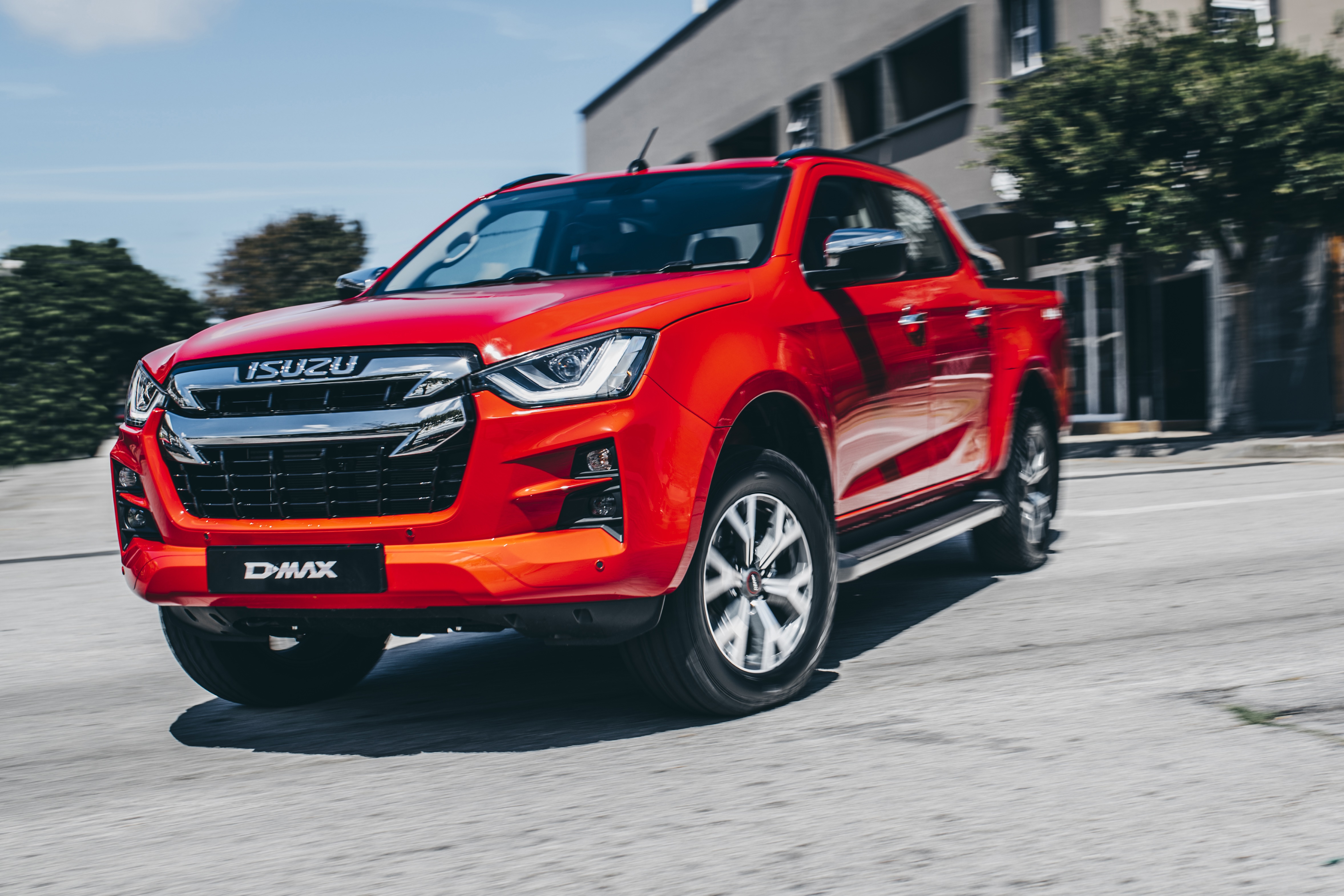 Red Isuzu D-Max 4K driving on a street HD Wallpaper
