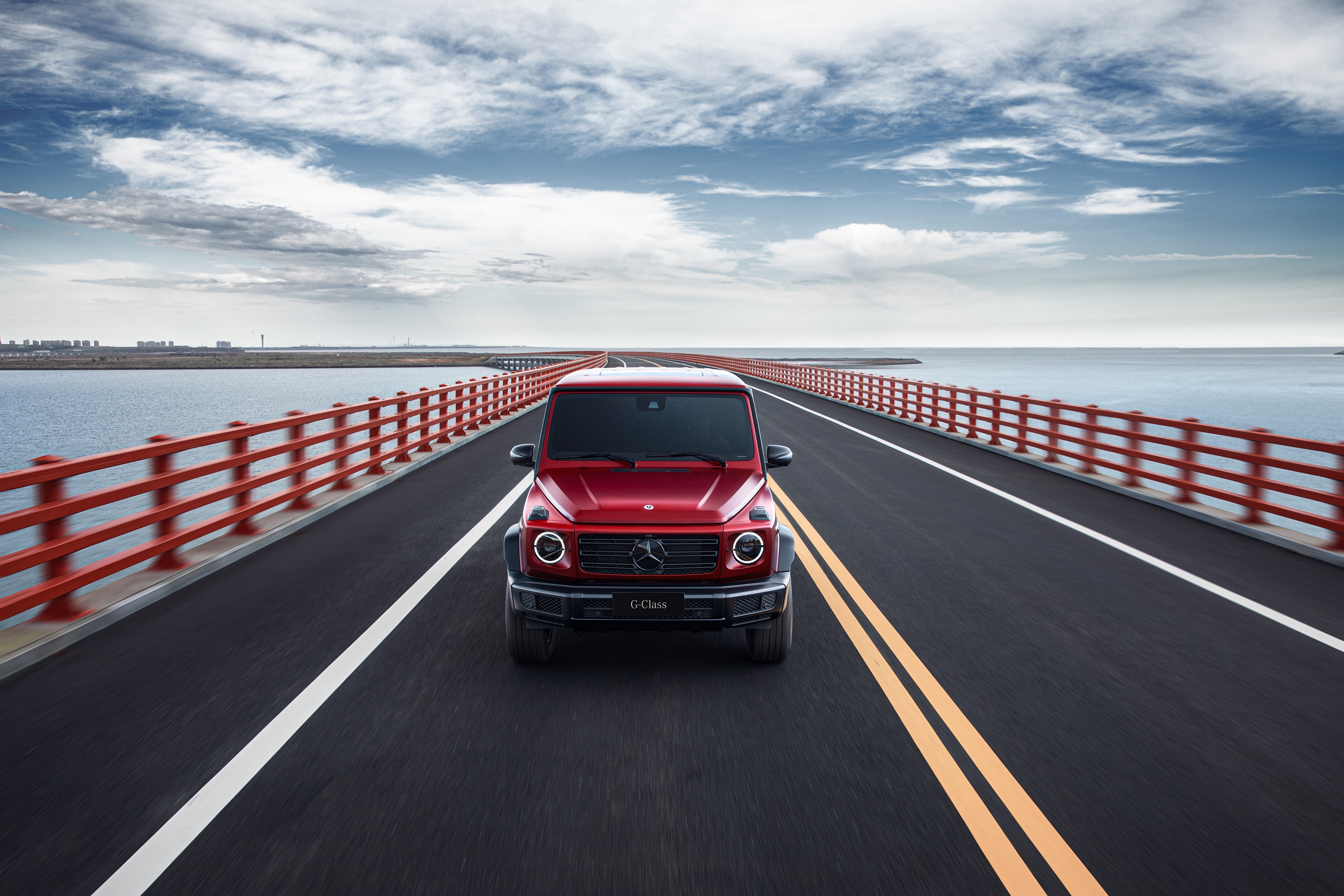 Red Mercedes-Benz G-Class driving on a bridge HD Wallpaper