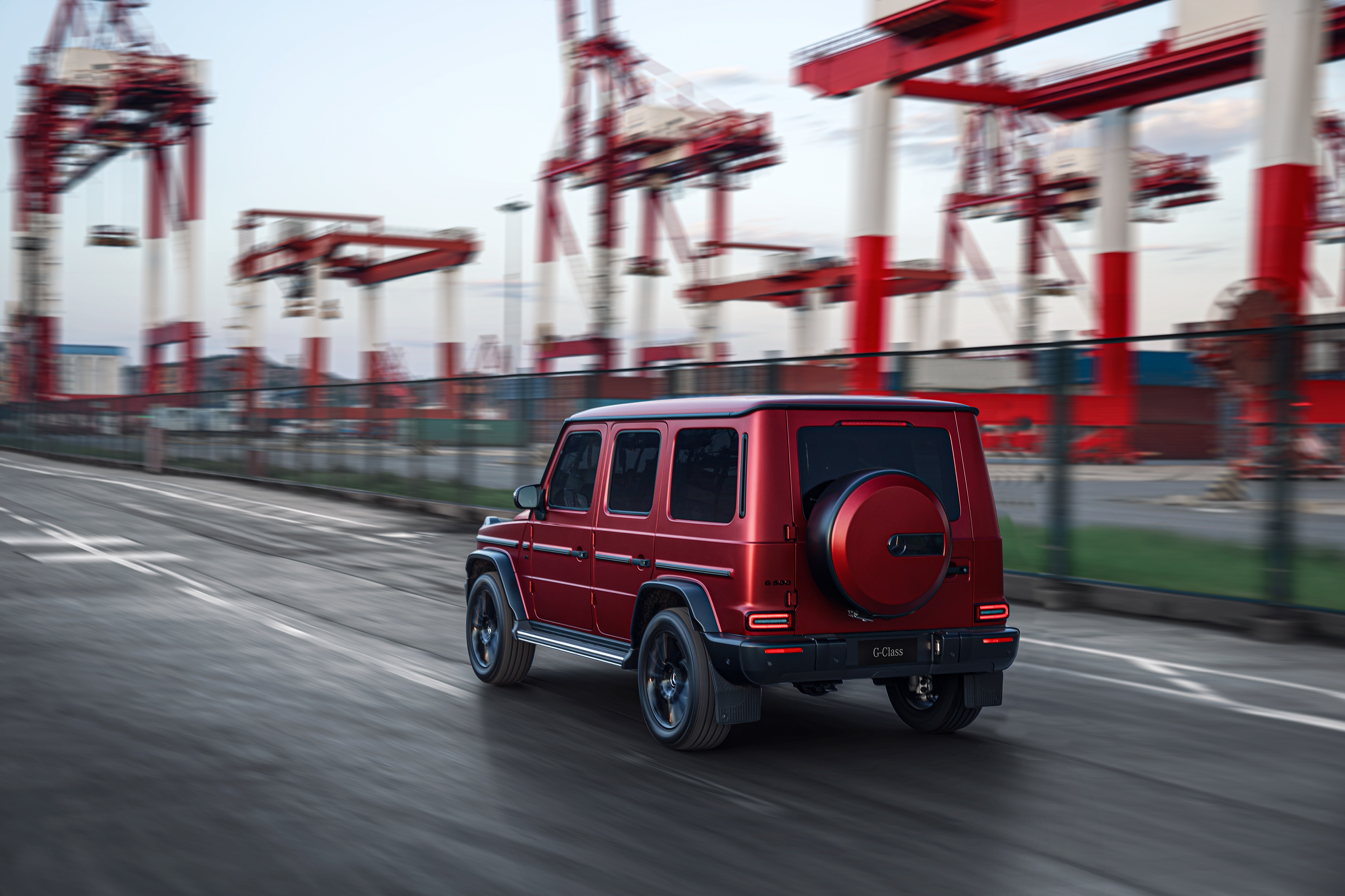 Red Mercedes-Benz G-Class driving in port HD Wallpaper