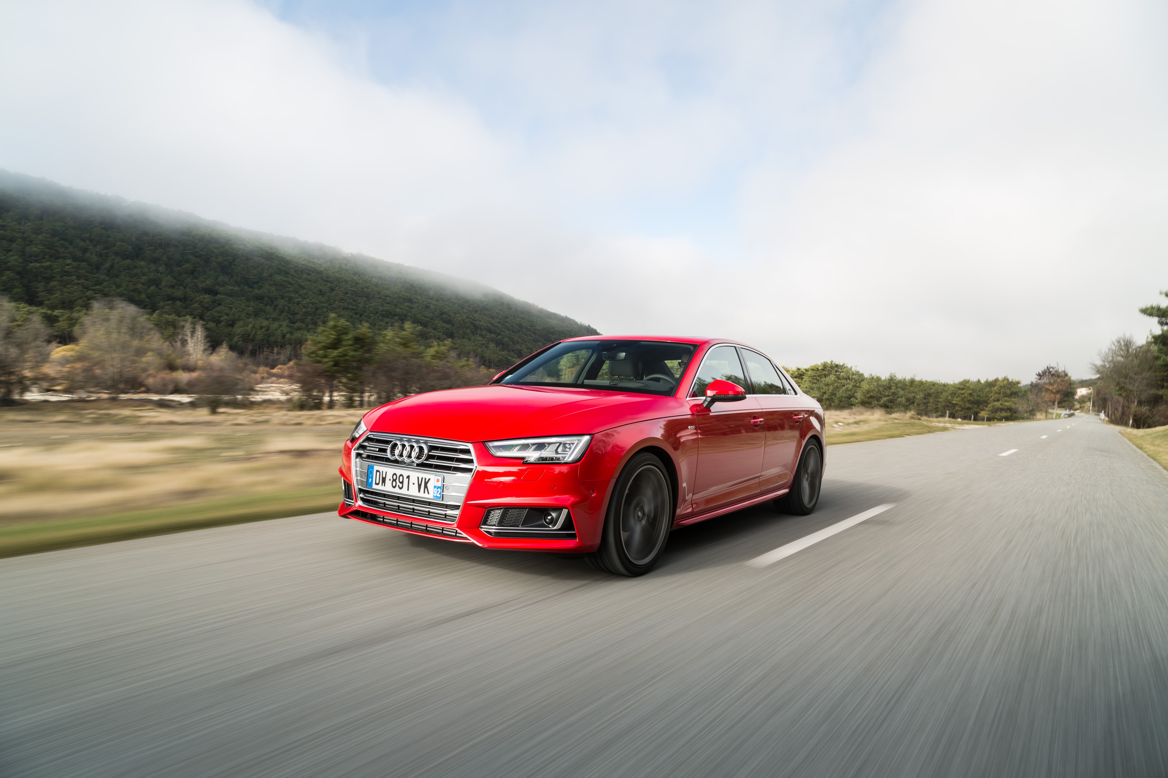 Red Audi A4 Sedan driving on a road HD Wallpaper