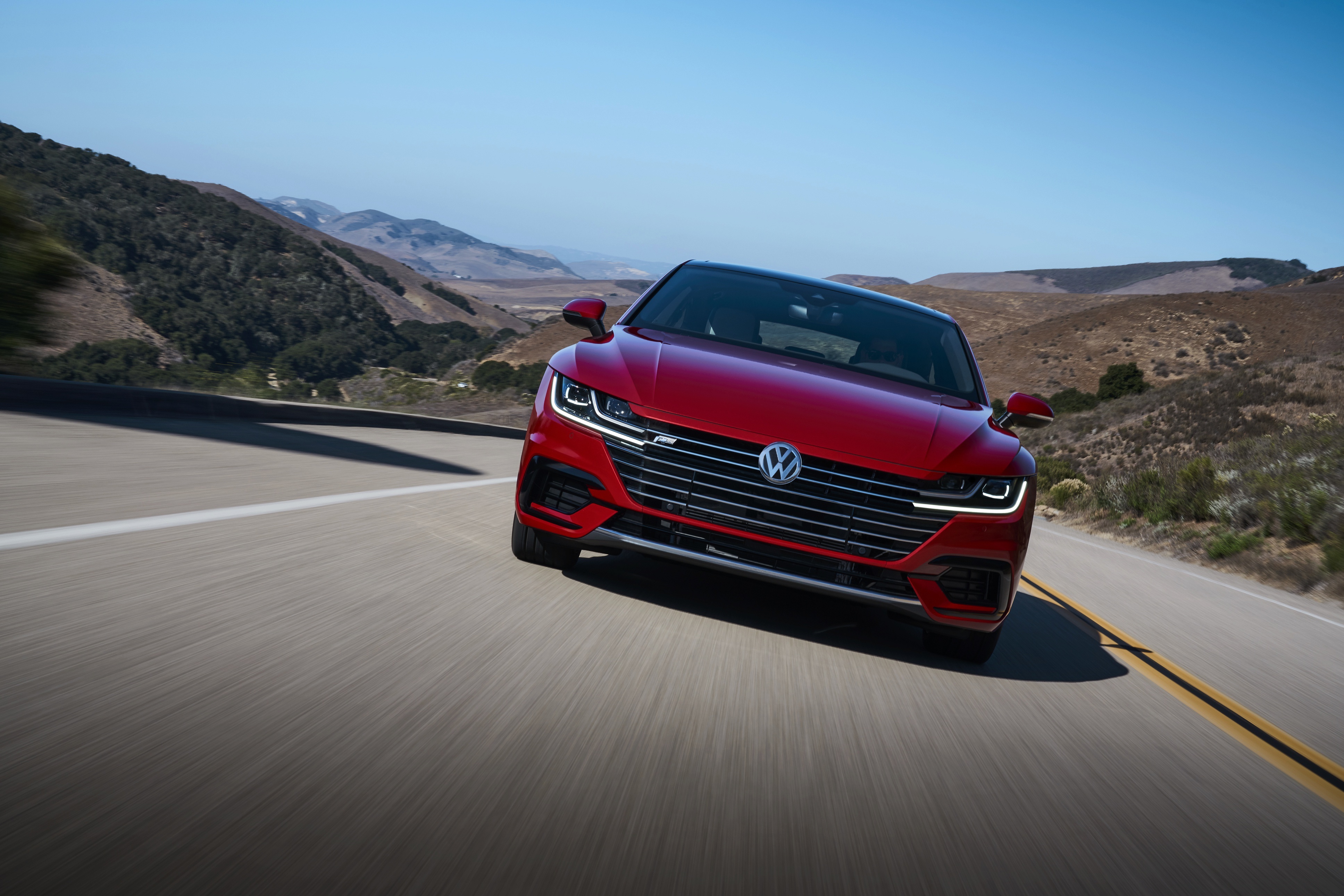 Red Volkswagen Arteon R-Line driving on a road HD Wallpaper