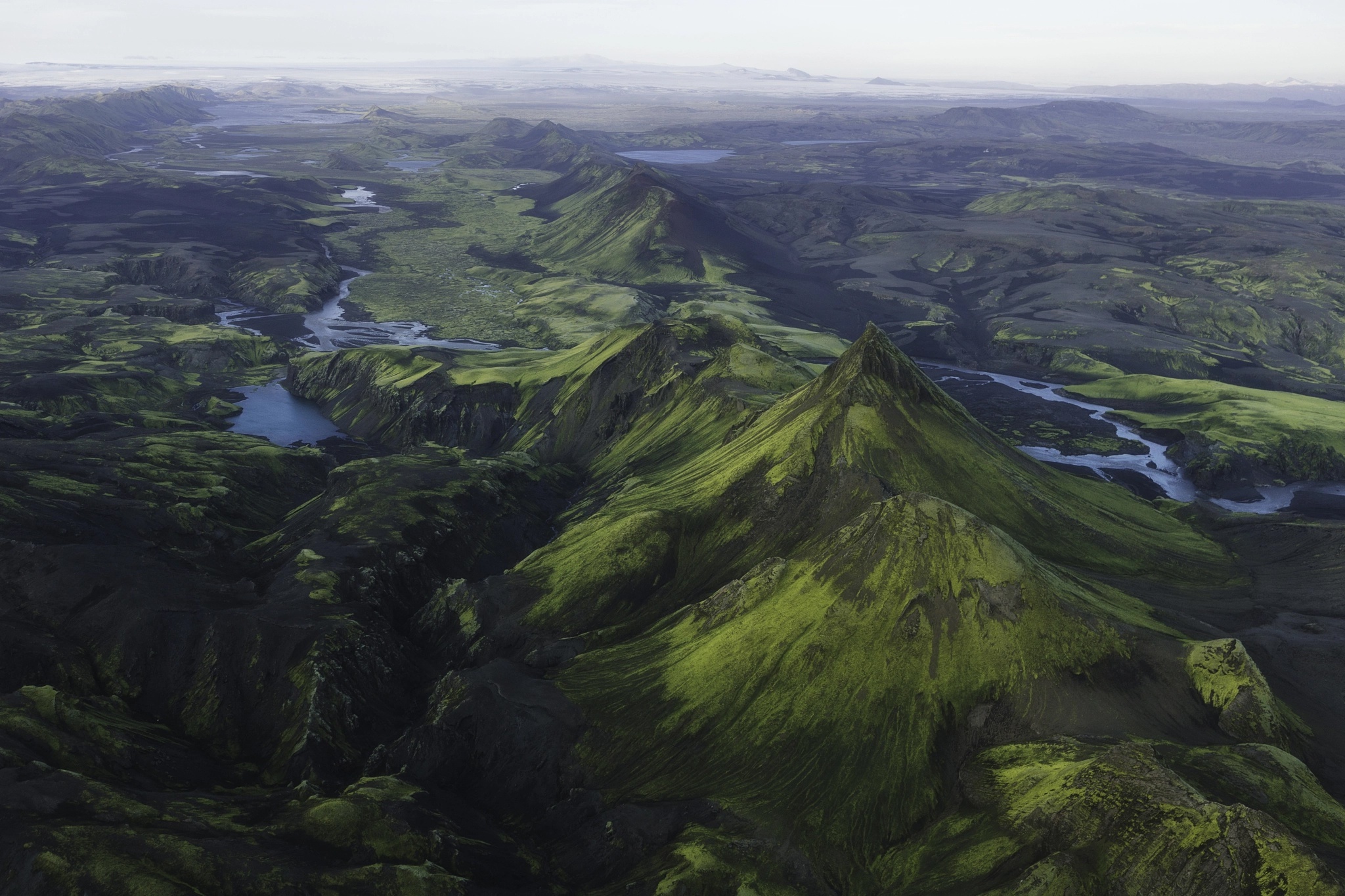 Aerial view of a green mountainous landscape in Iceland HD Wallpaper