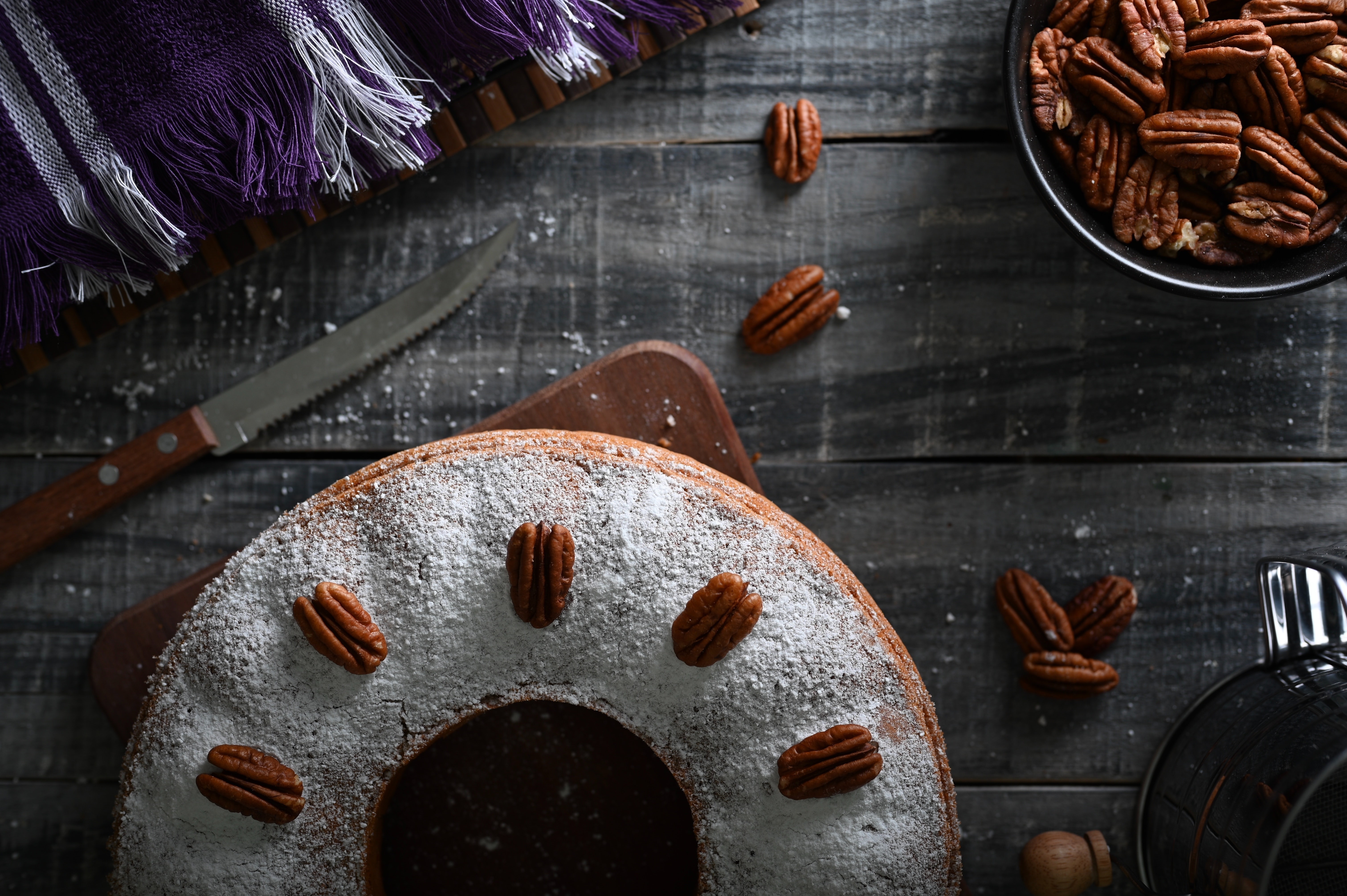 Bundt cake with pecans and powdered sugar HD Wallpaper