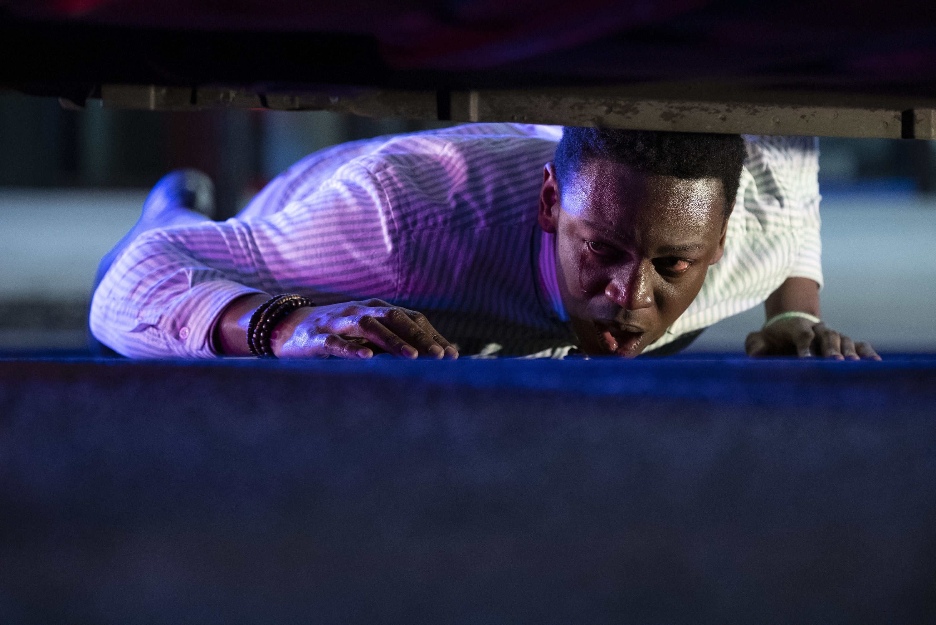 Man crawling under a vehicle HD Wallpaper