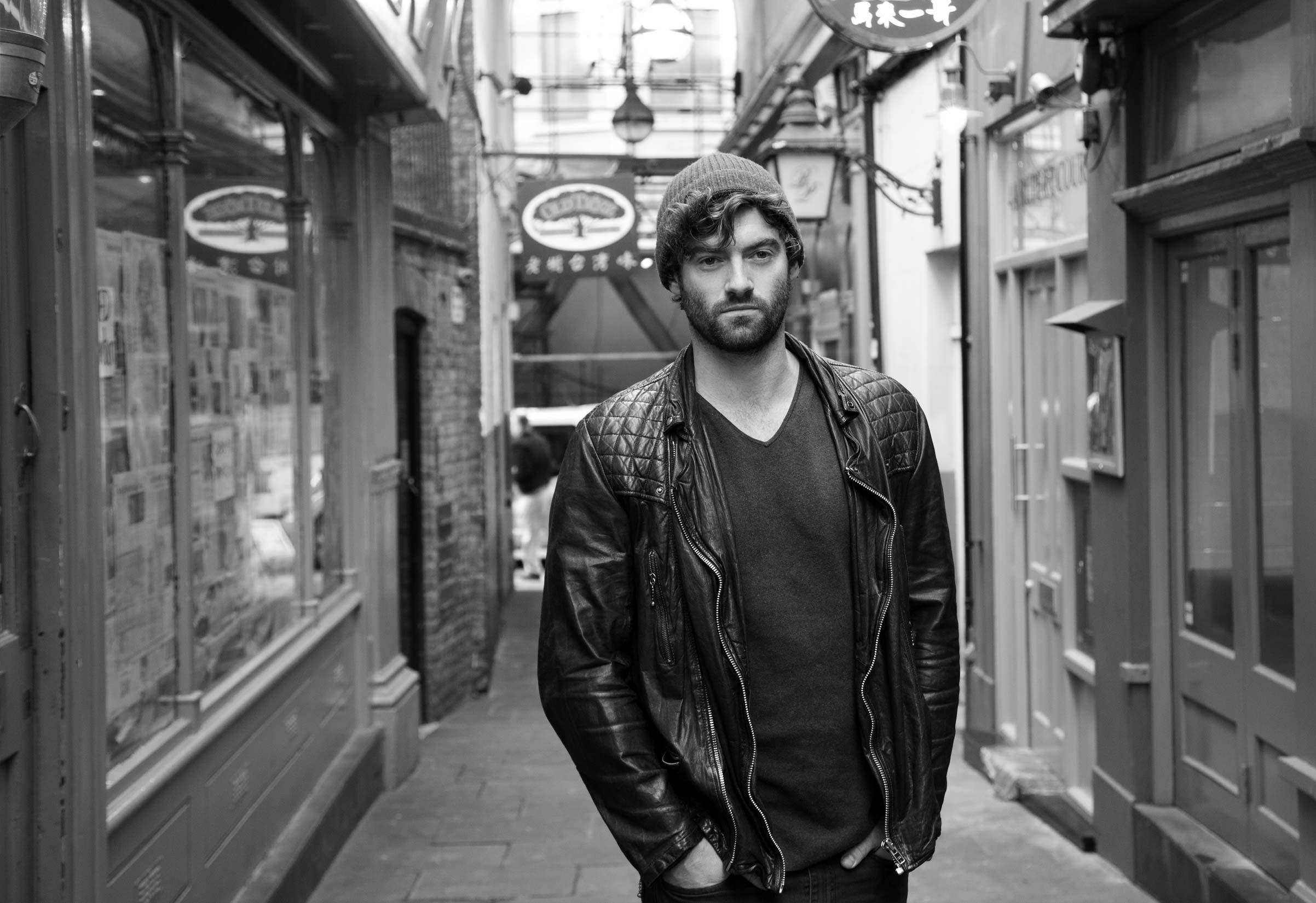 Stuart Martin in a leather jacket and beanie HD Wallpaper