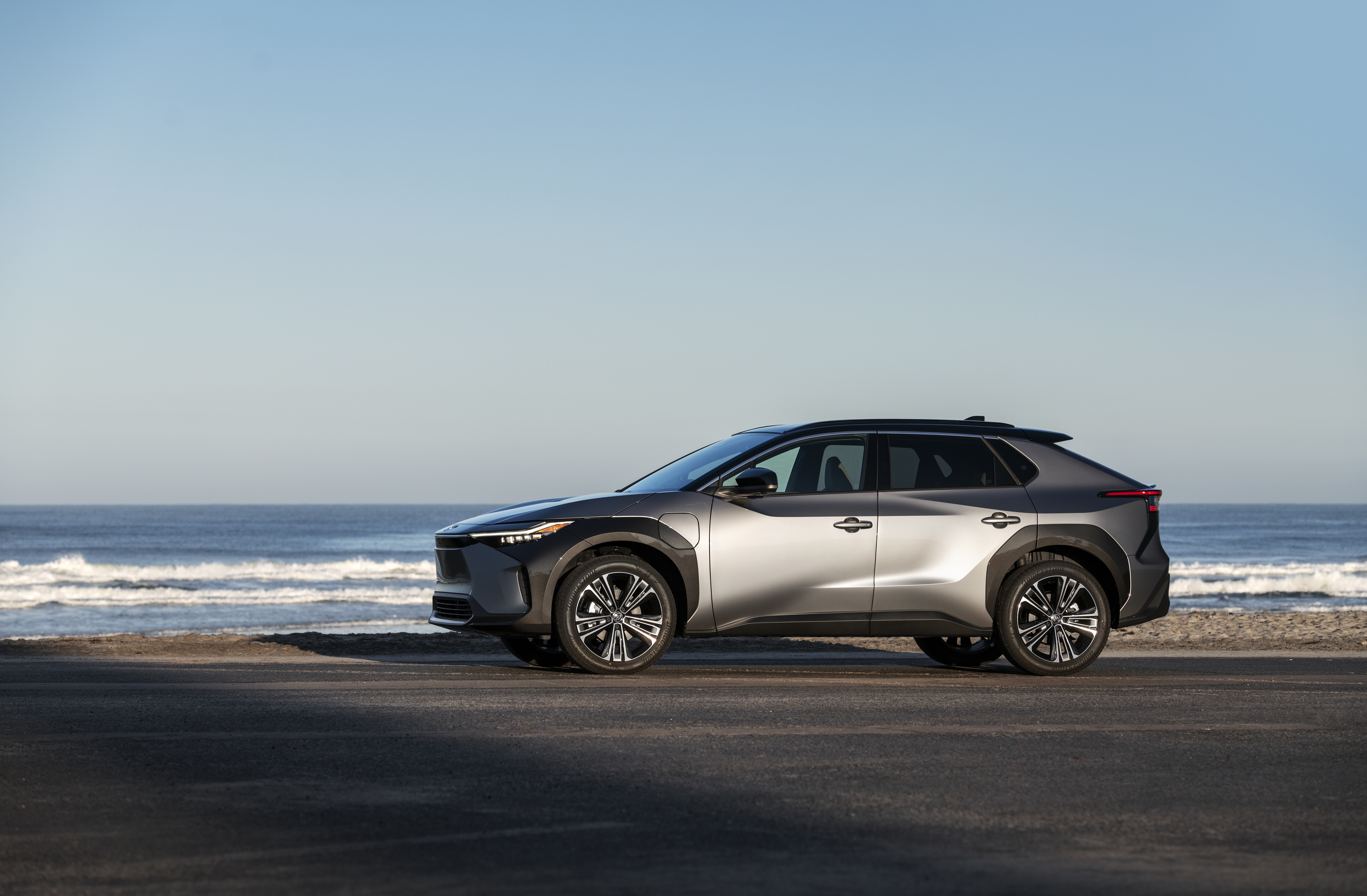 Toyota BZ4X parked by the ocean HD Wallpaper