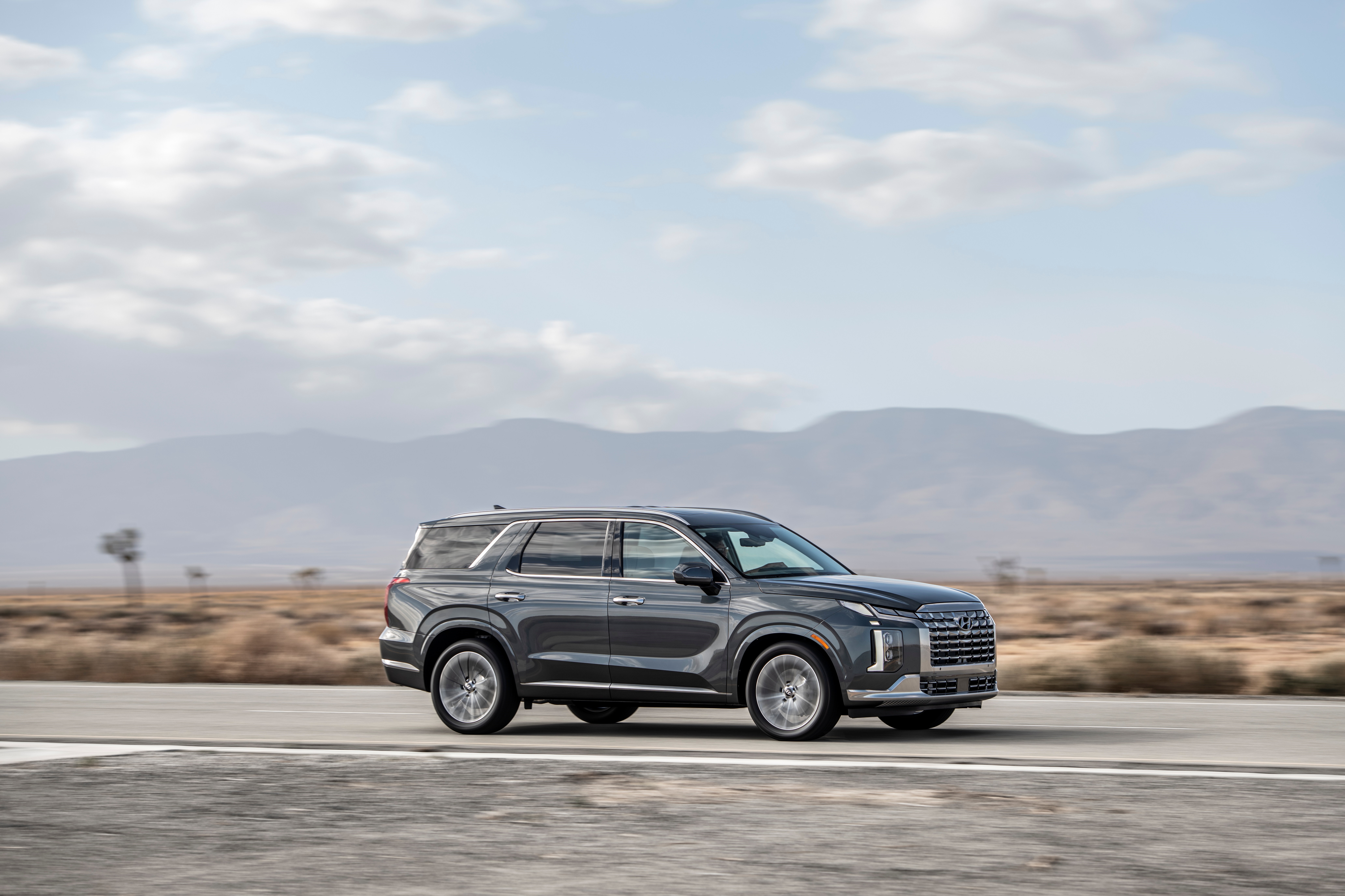 Hyundai Palisade driving on a desert road HD Wallpaper