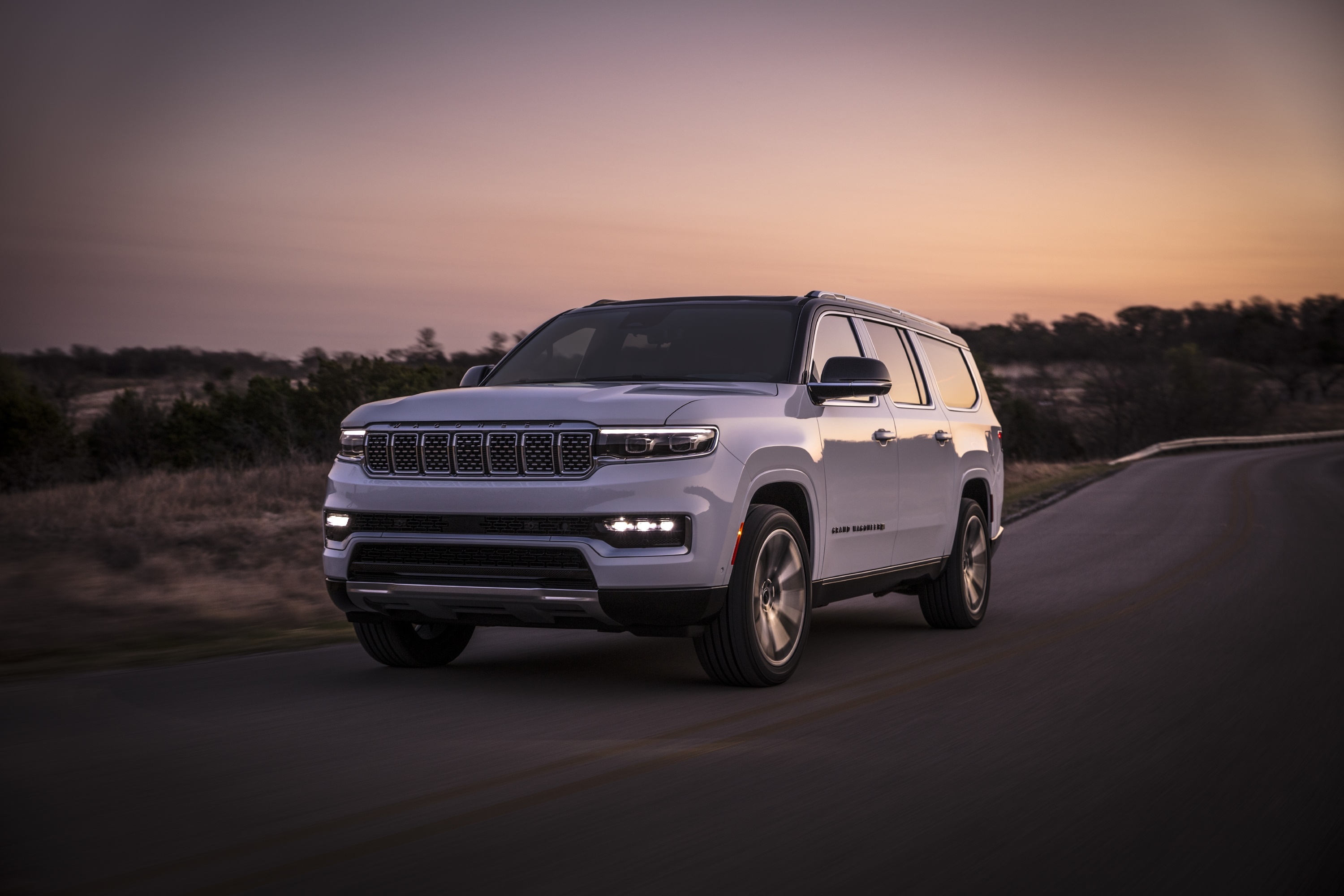 White Jeep Wagoneer HD driving on a road at sunset HD Wallpaper