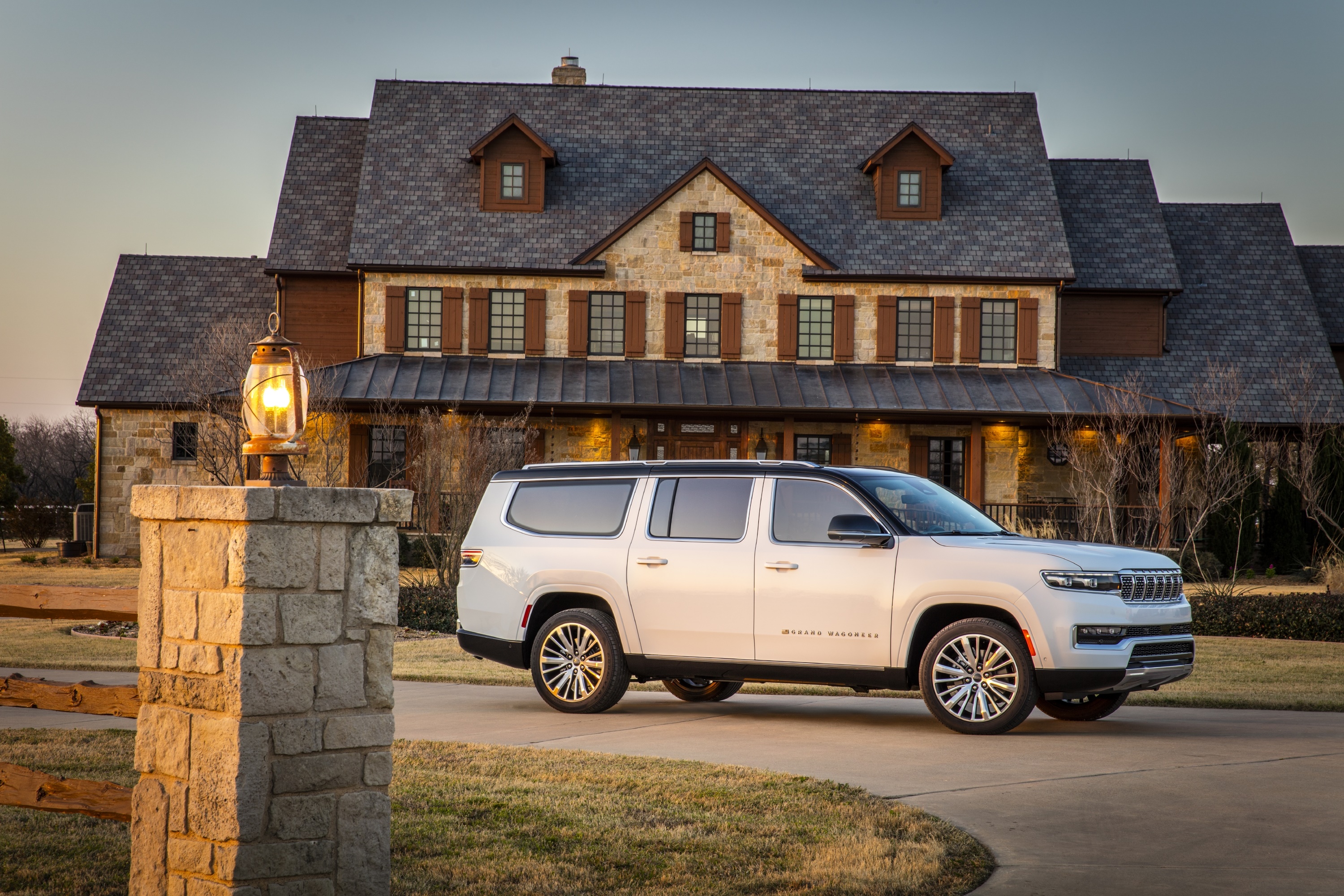 White Jeep Grand Wagoneer parked in front of a stone house HD Wallpaper