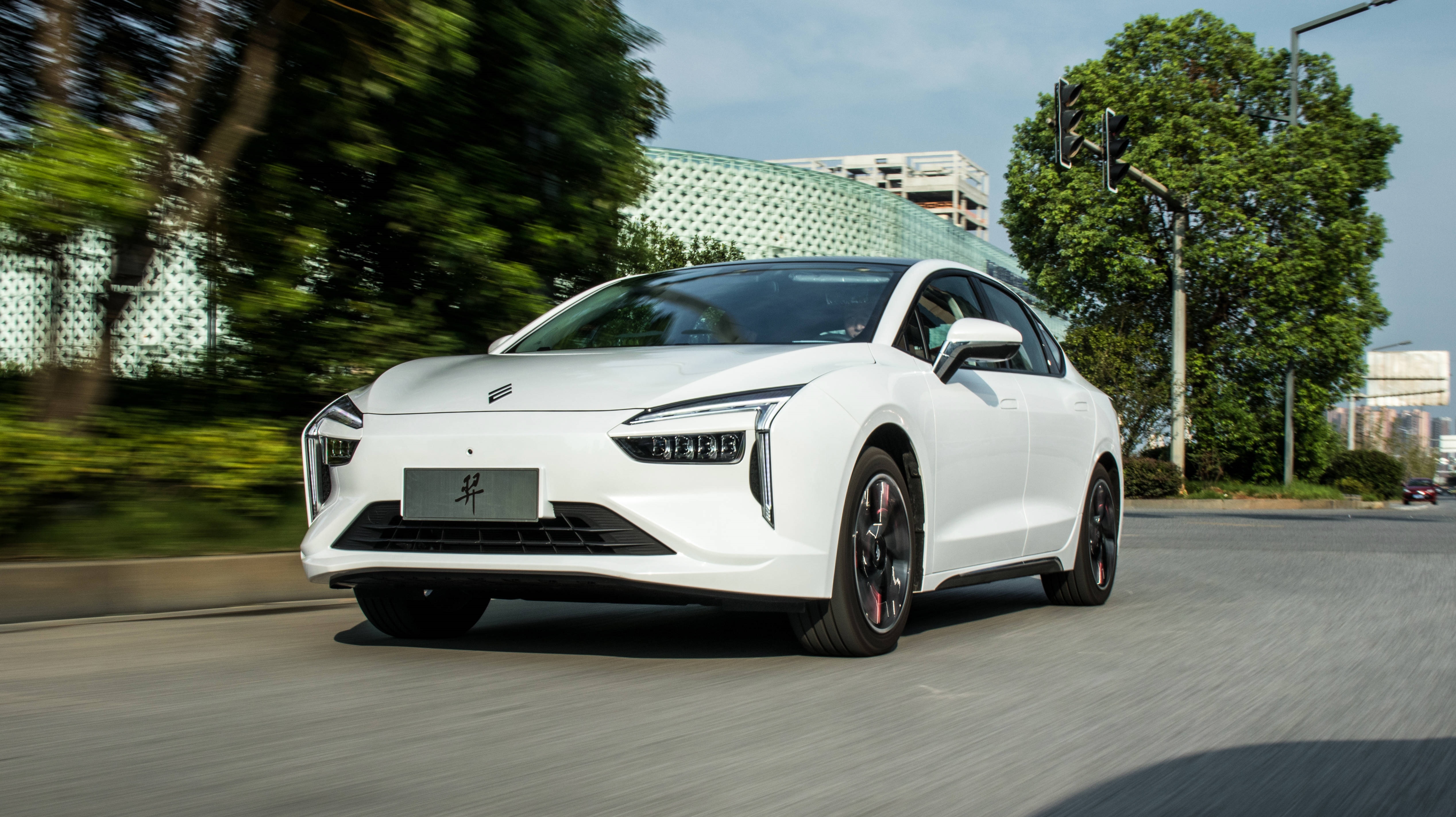 JMEV Yi 4K electric car driving on road HD Wallpaper