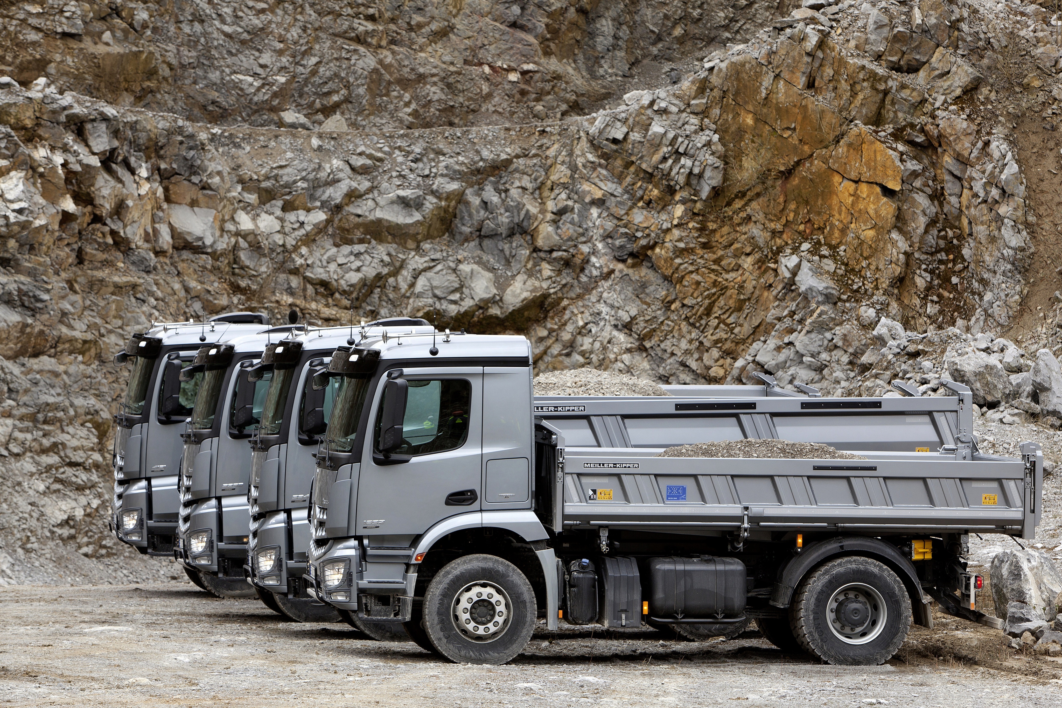 Mercedes-Benz Arocs dump trucks in a quarry HD Wallpaper