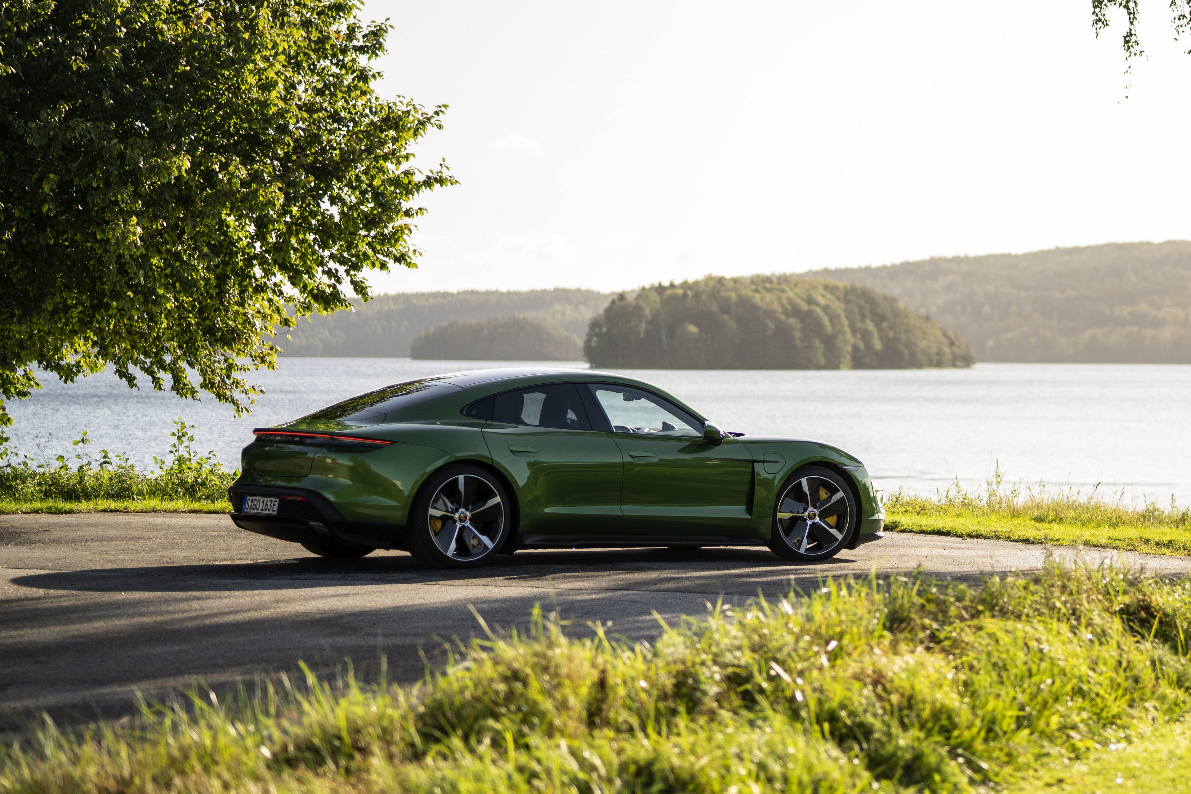 Green Porsche Taycan 4S parked by a lake HD Wallpaper