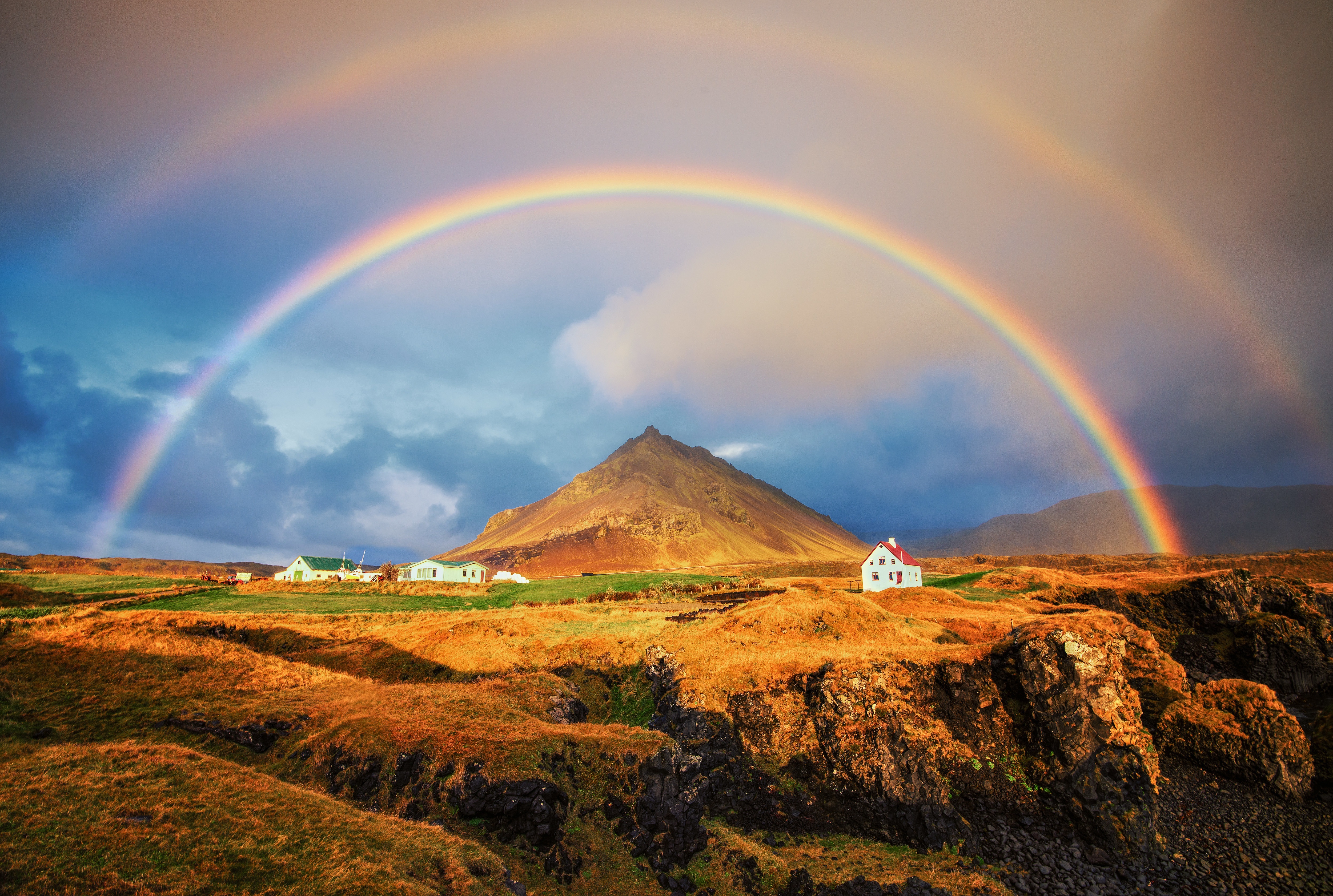 Double rainbow over Icelandic landscape with houses HD Wallpaper