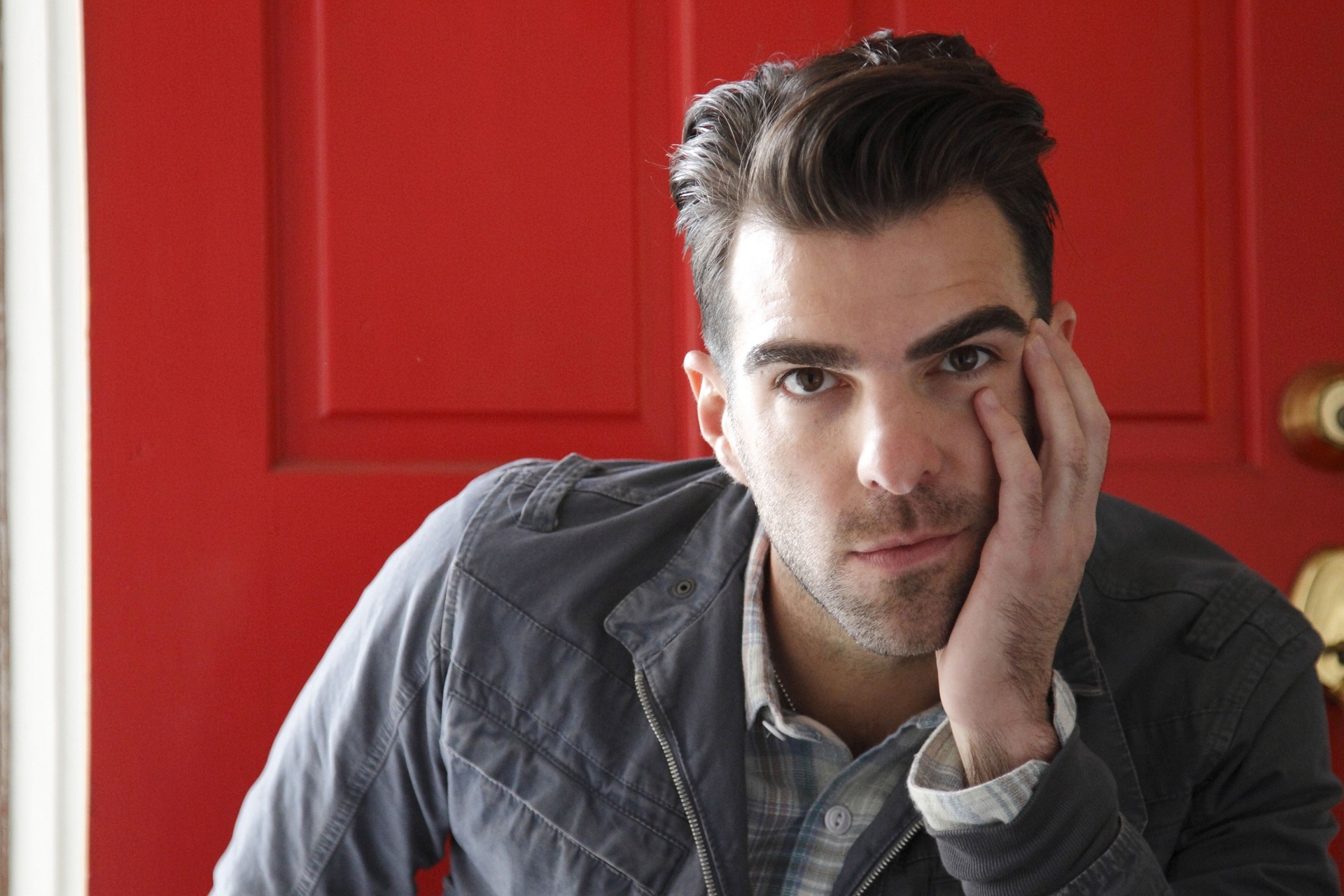 Zachary Quinto posing in front of a red door HD Wallpaper