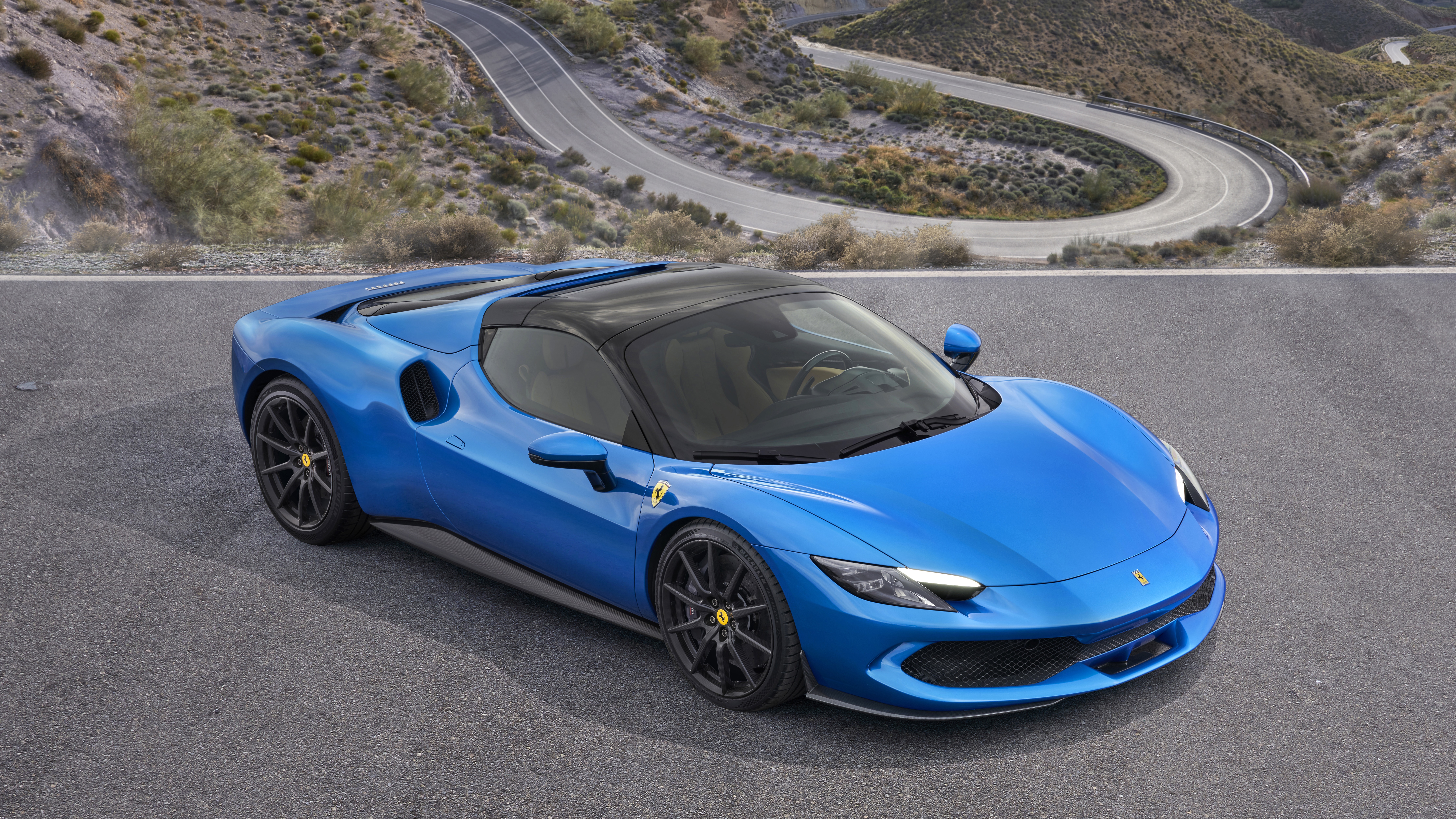 Blue Ferrari 296 GTS on a winding road HD Wallpaper