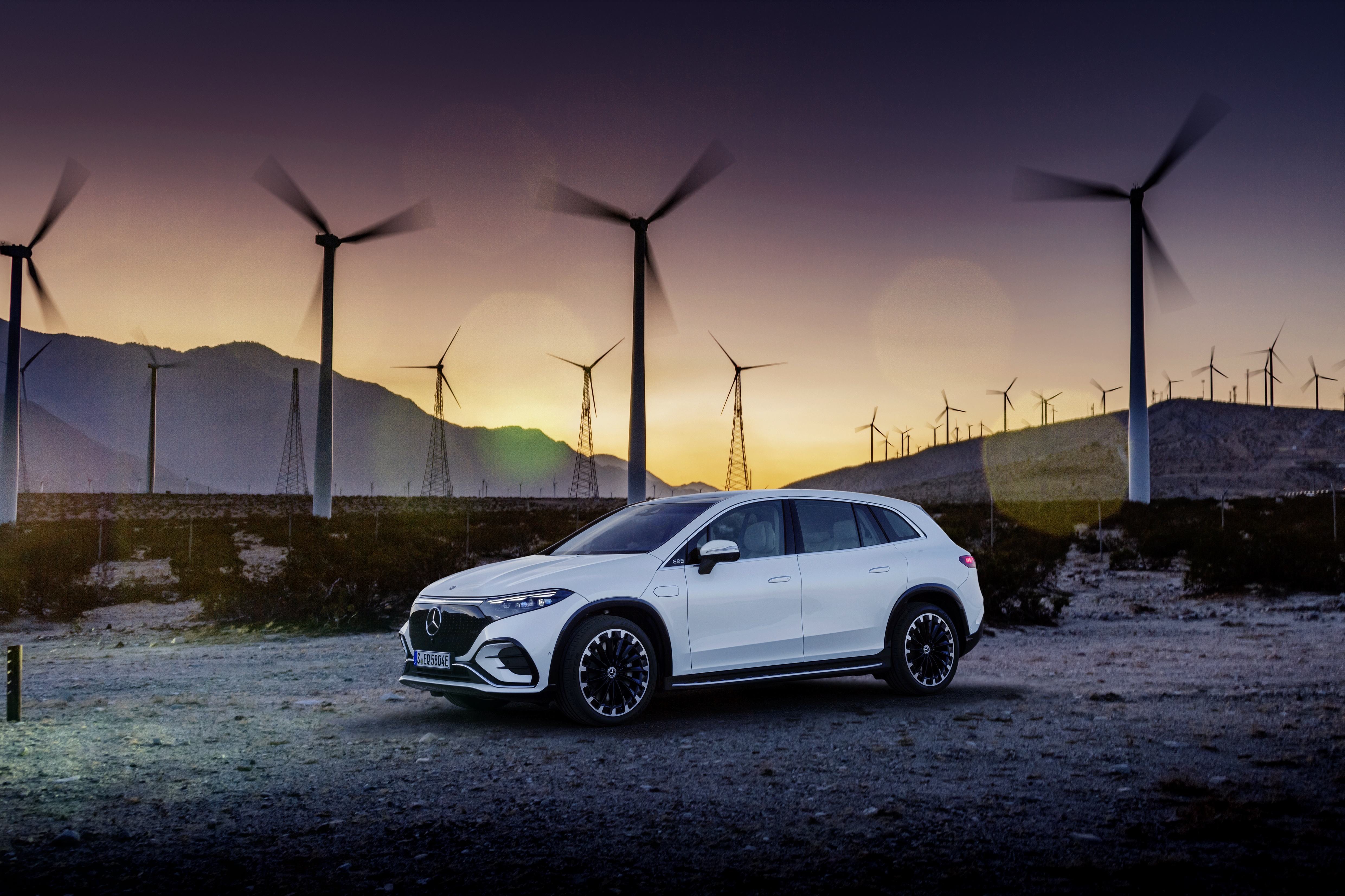 White Mercedes-Benz EQS 450+ 4K SUV near wind turbines HD Wallpaper