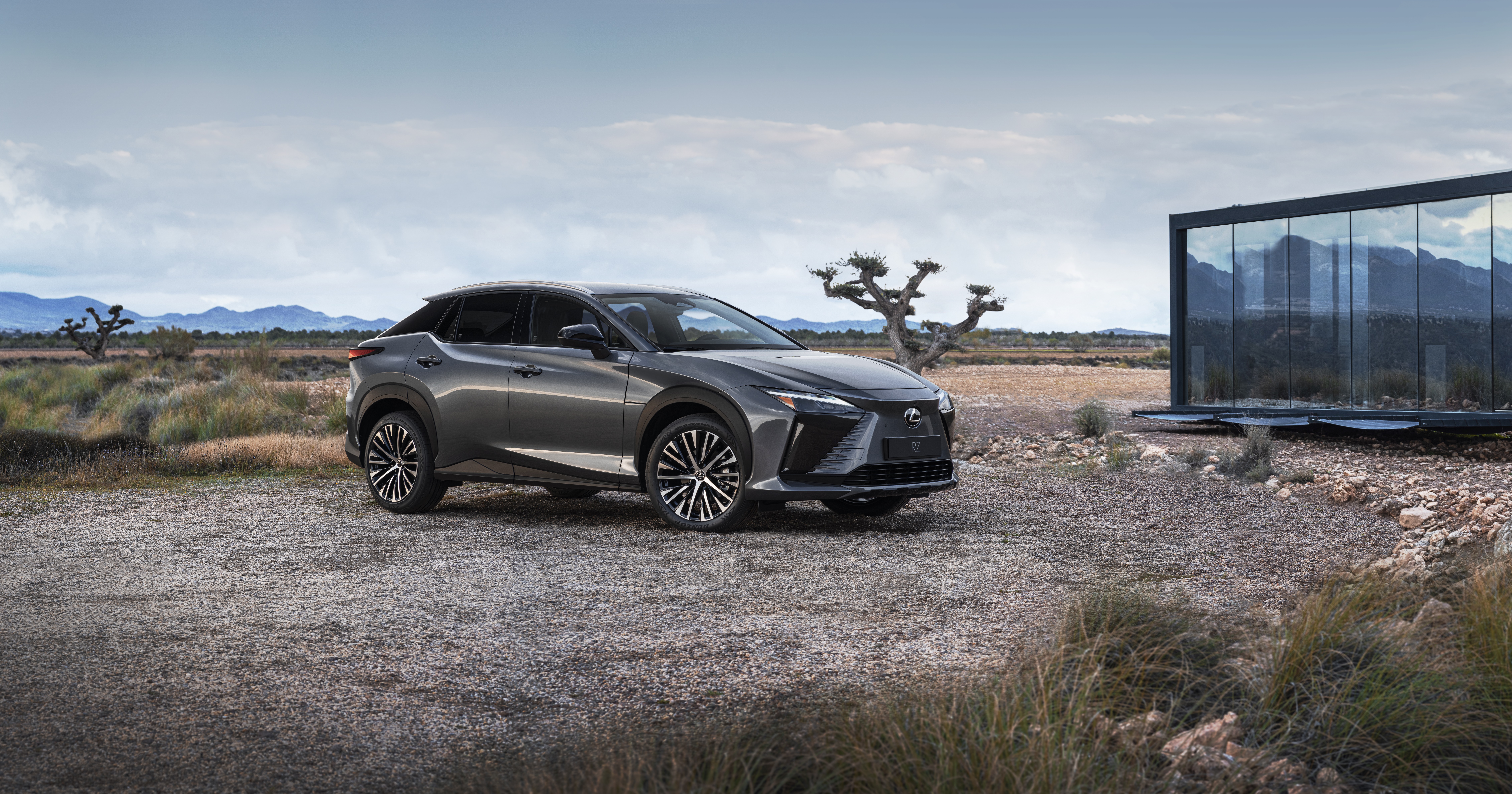 Lexus RZ 450e electric SUV in desert landscape HD Wallpaper
