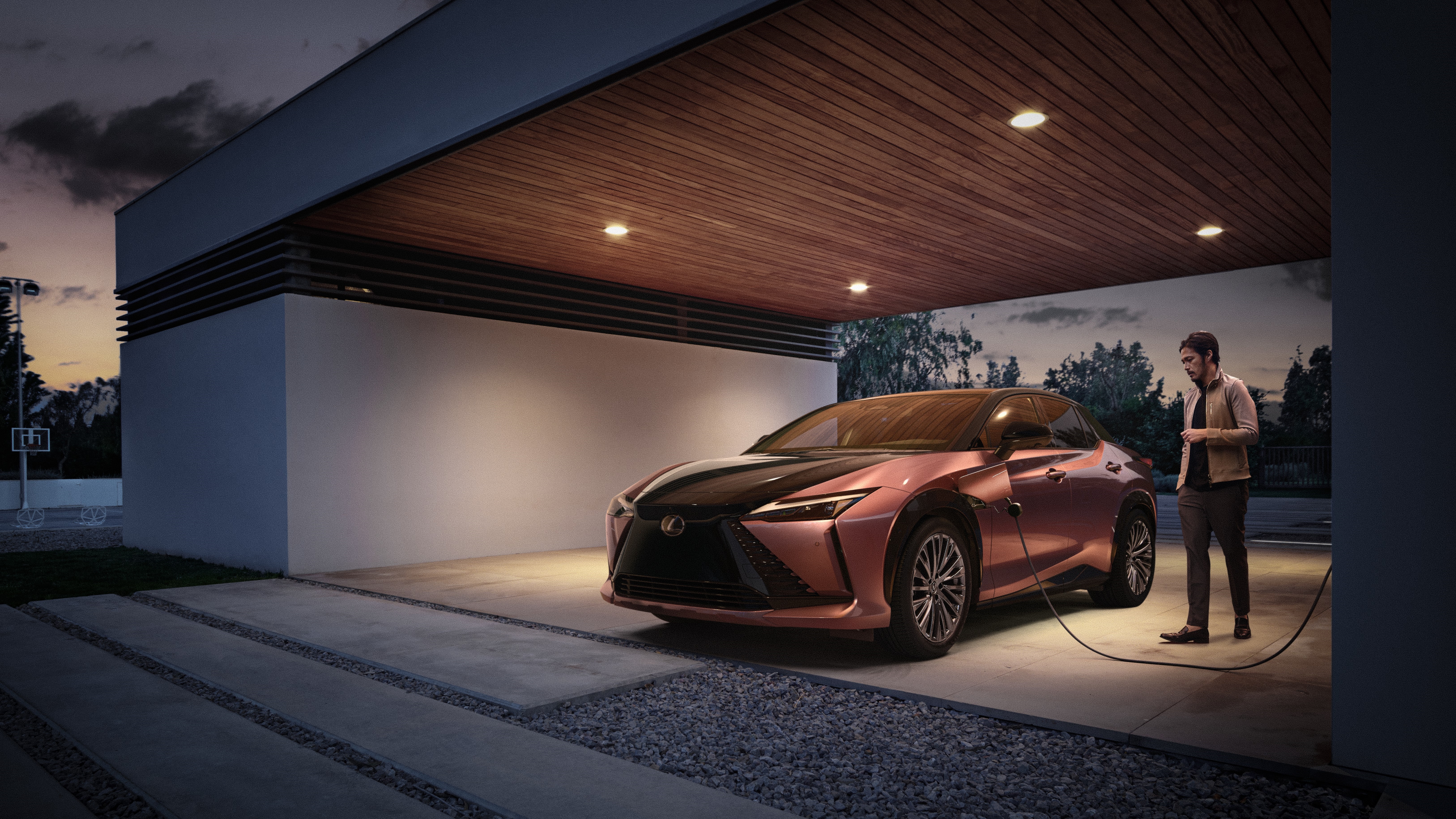 Lexus RZ 450e charging at dusk HD Wallpaper
