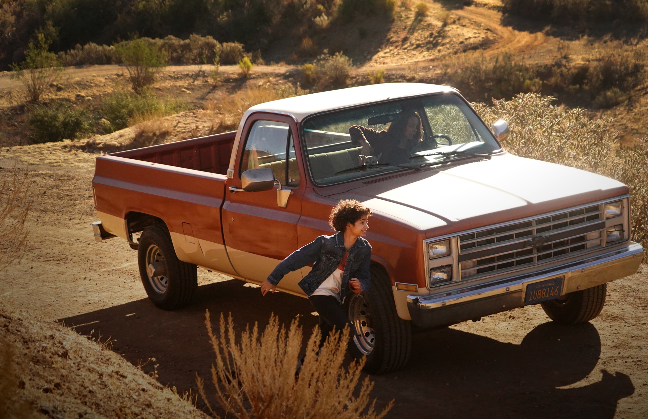 Girl running next to a pickup truck HD Wallpaper