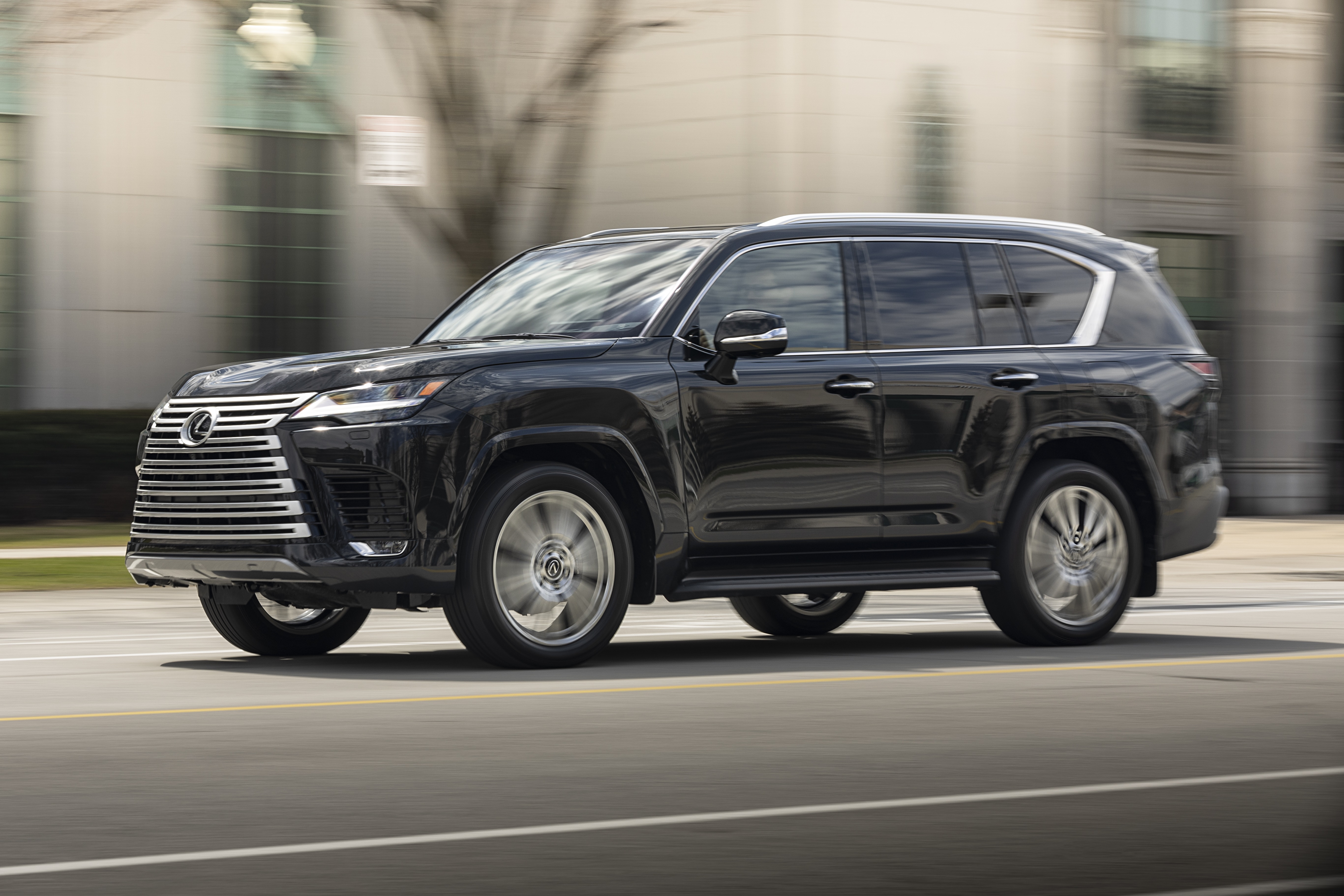 Black Lexus LX 600 4K driving on a street HD Wallpaper