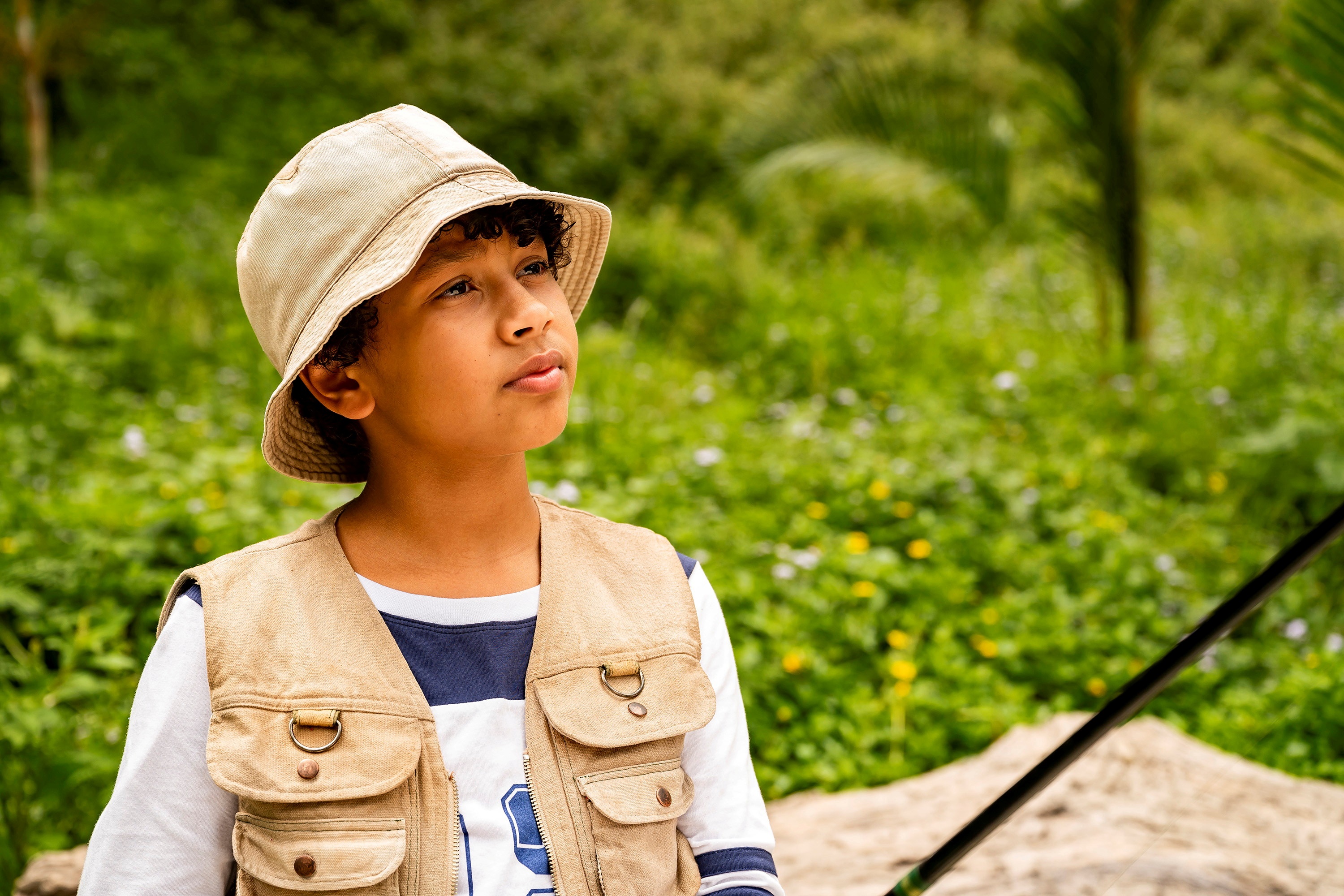 Young boy in fishing vest and hat HD Wallpaper